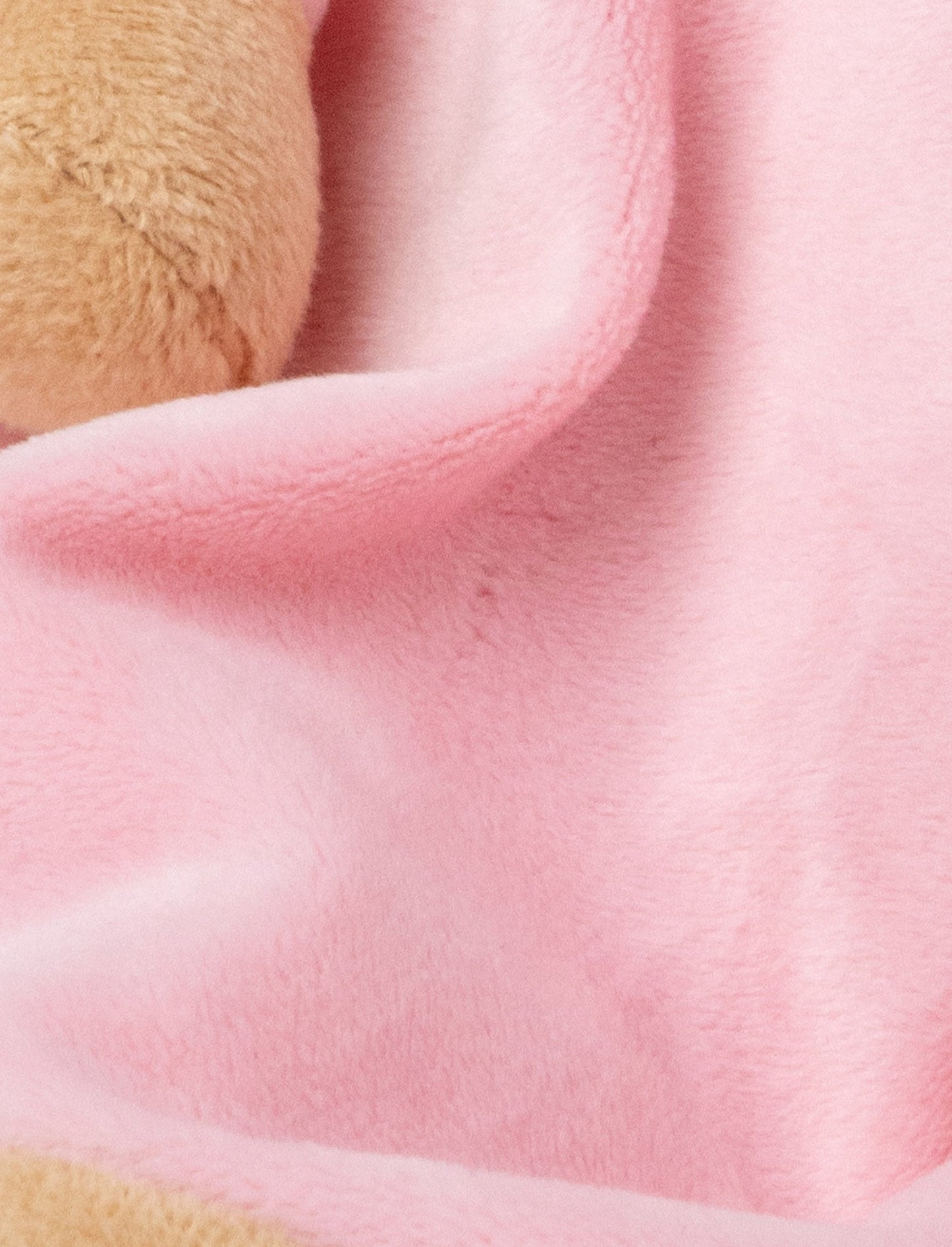 A pink baby blanket with a soft plush cat, white and beige details