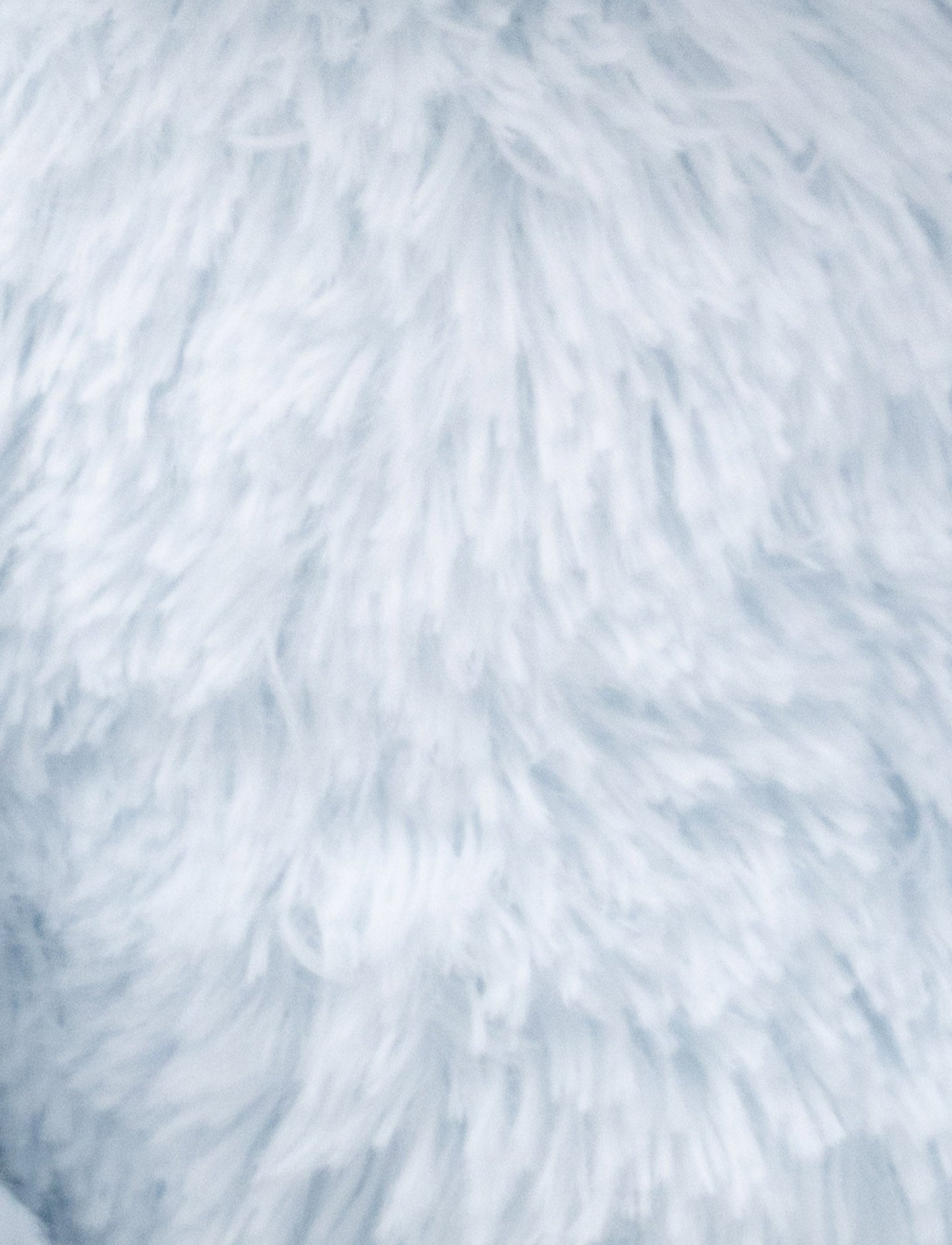 A soft blue plush bunny with floppy ears, a beige nose, and golden-stitched eyes.