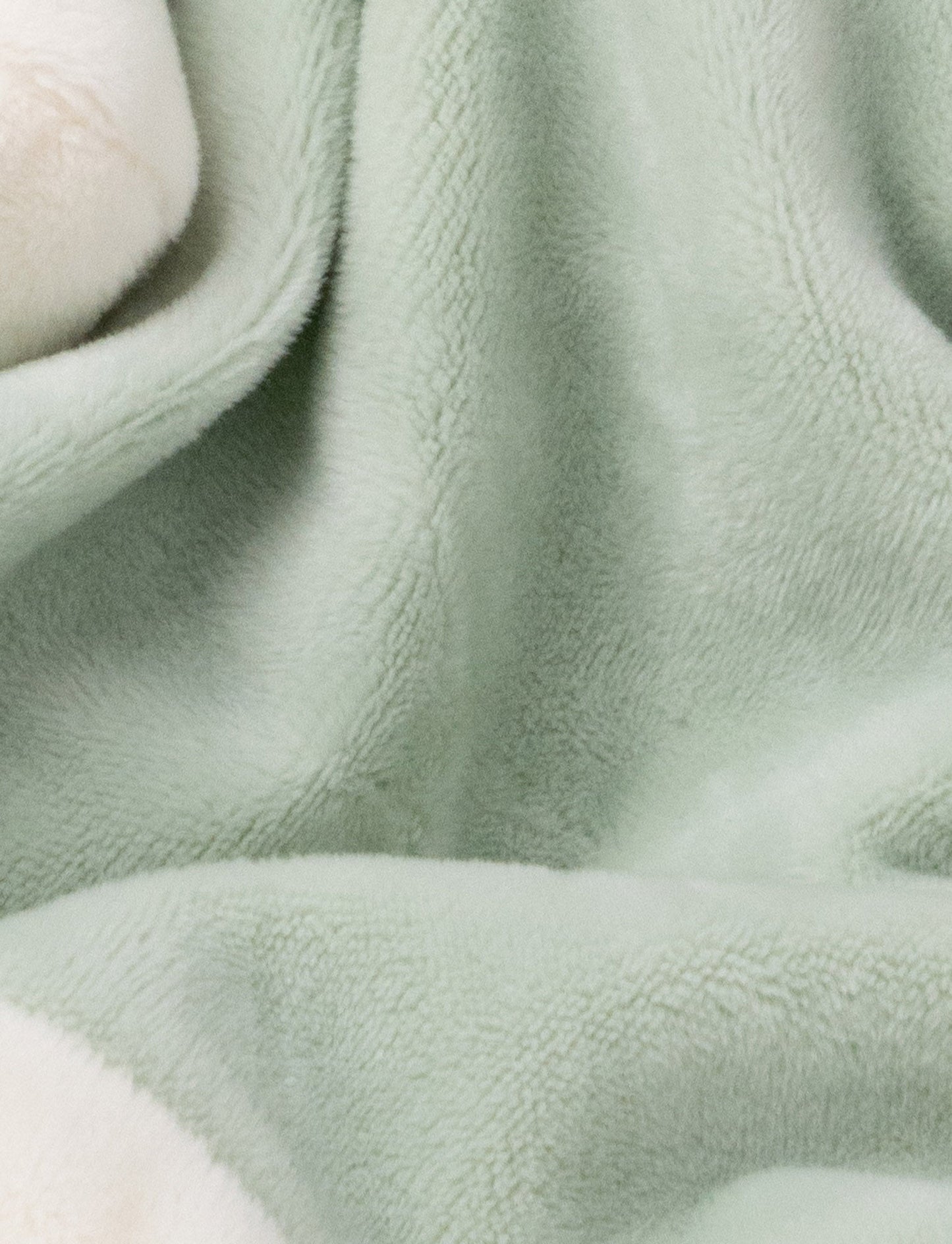 Soft baby blanket with a plush green bunny head, long floppy ears, and white-trimmed edges.