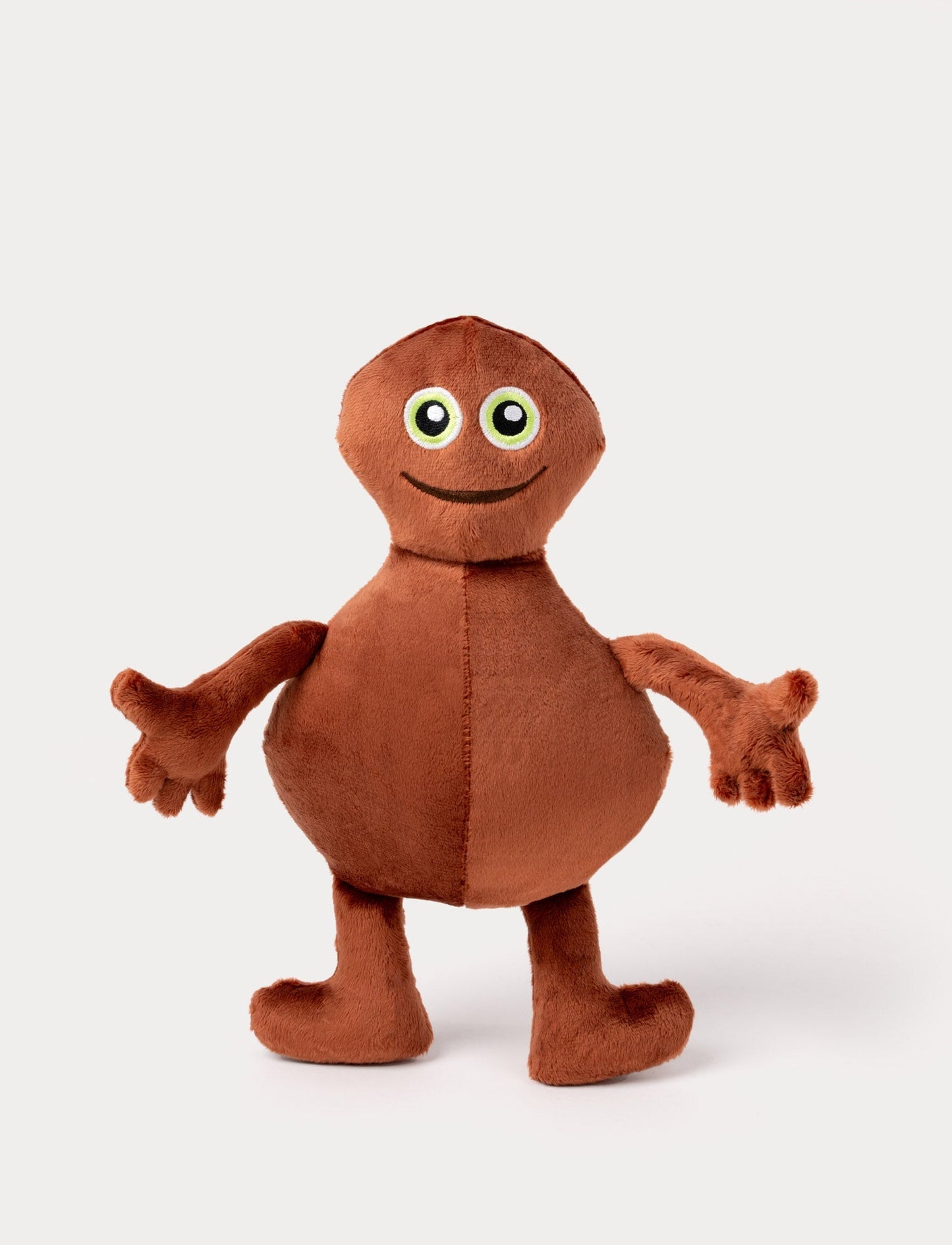Brown plush toy with a round body, long arms, big green eyes, and a friendly embroidered smile.