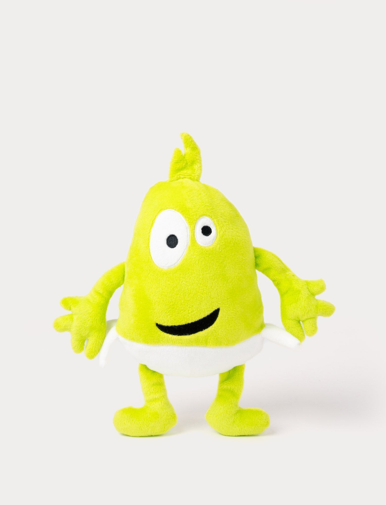  Image of Green plush toy with a tuft on top, large uneven eyes, a wide smile, and a white waistband.