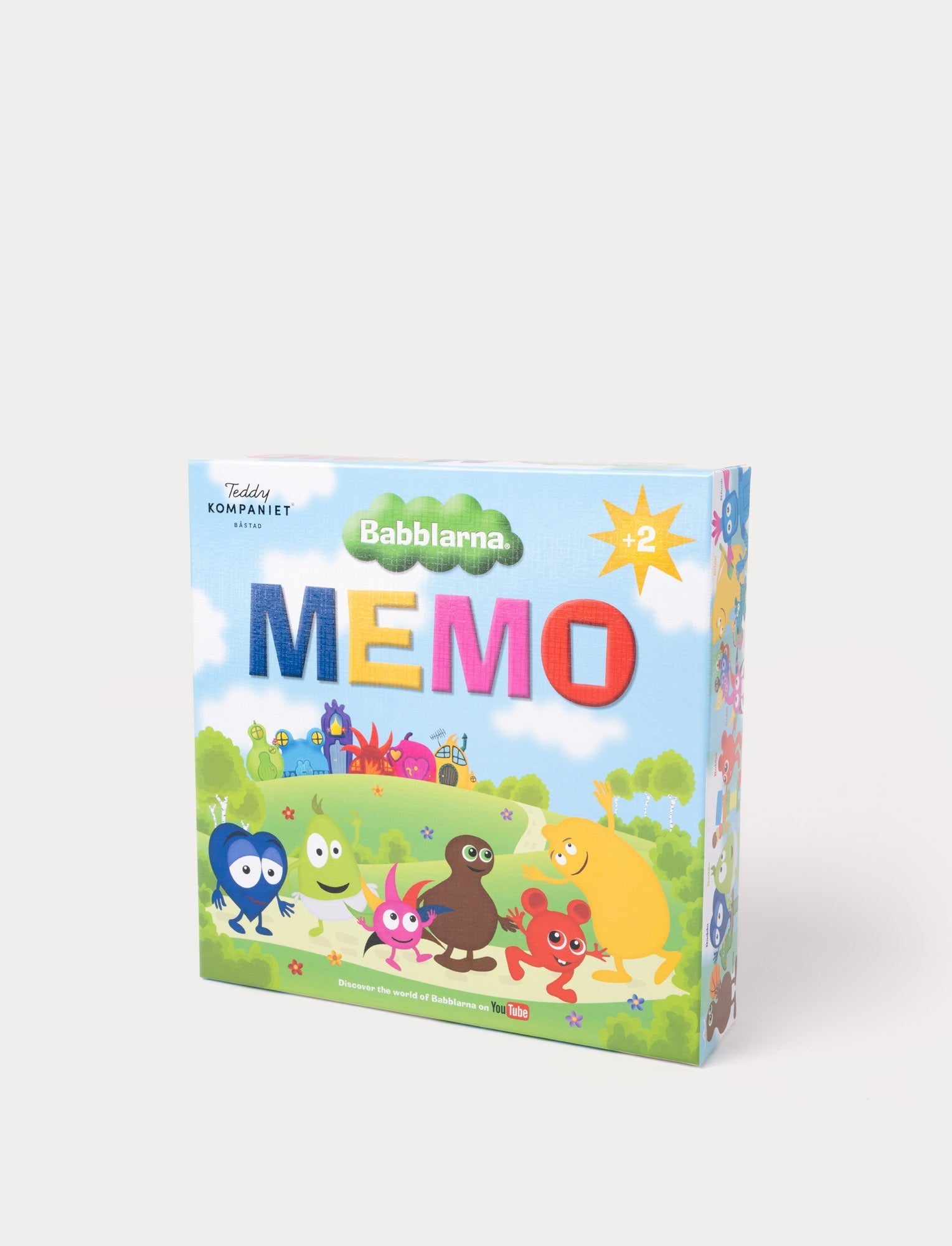  Image of A box of the Babblarna Memo game with colorful characters on a grassy landscape under a blue sky.