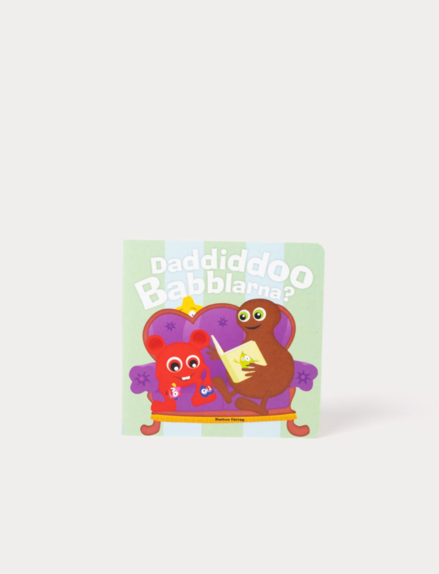 children's book with colorful Babblarna characters in a cozy living room scene.