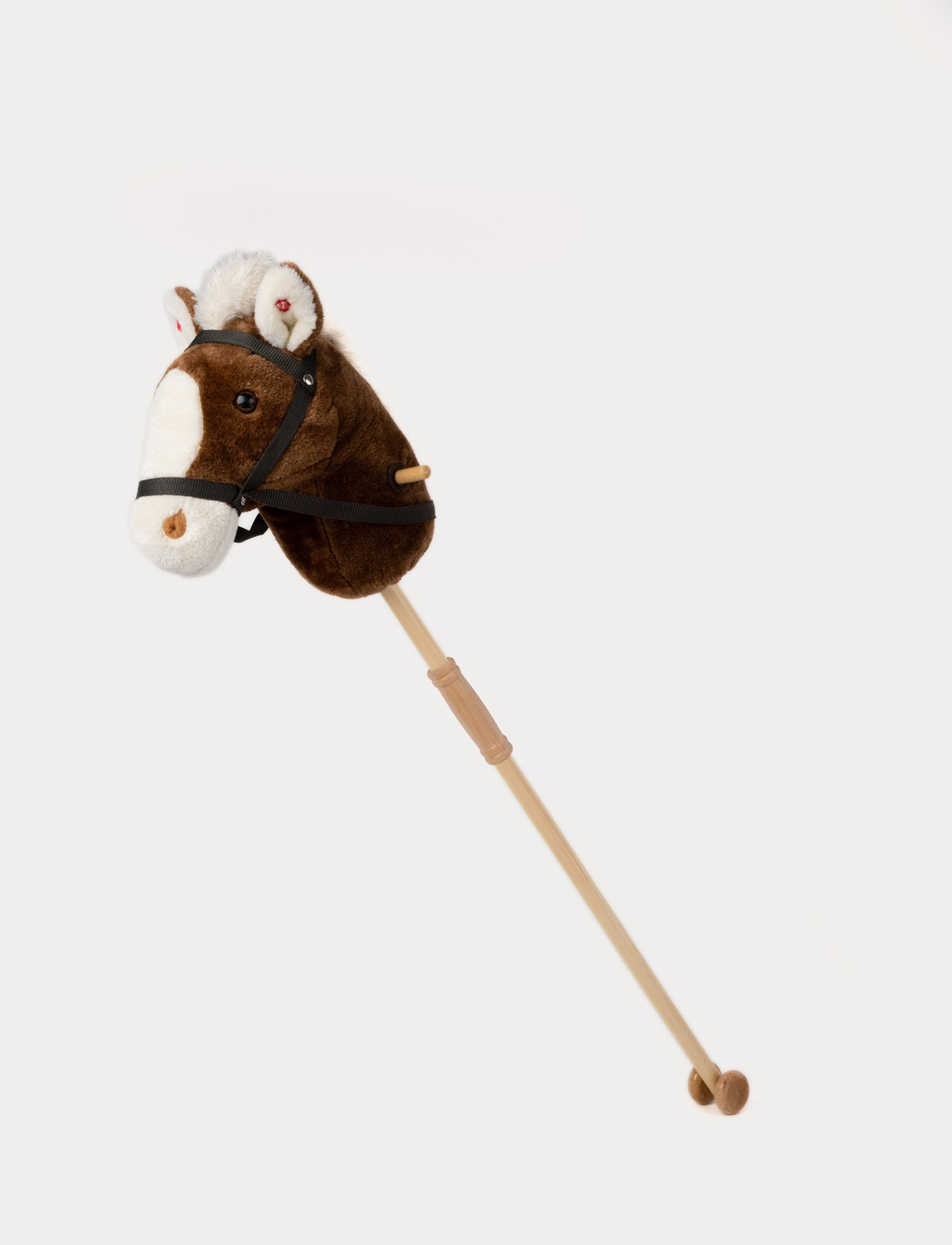  Image of Classic brown plush hobby horse with a wooden stick, black bridle, and soft white mane.