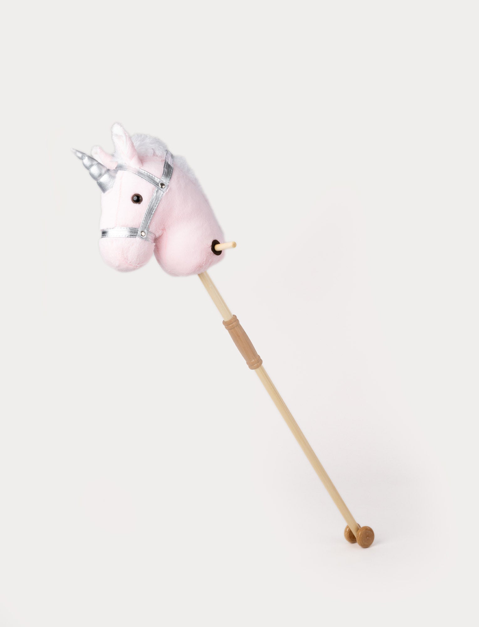  Image of Plush hobby unicorn with a soft pink head, silver horn, matching bridle, and a wooden stick with wheels.