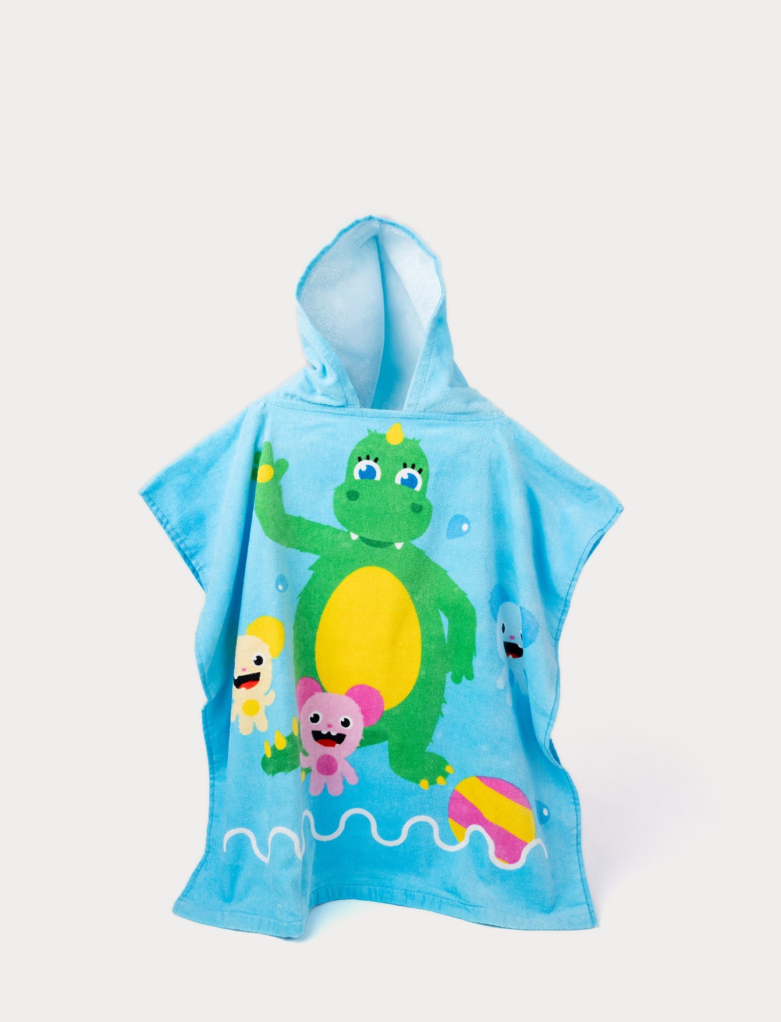  Image of Bolibompa beach poncho with a green dragon and colorful characters in the water