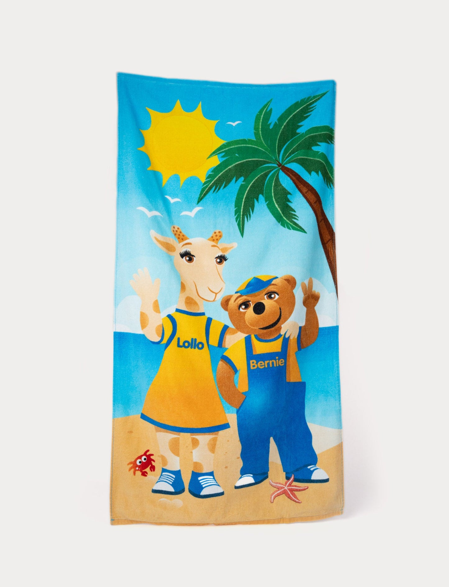 Lollo & Bernie beach towel with a sunny beach scene and colorful character illustrations.