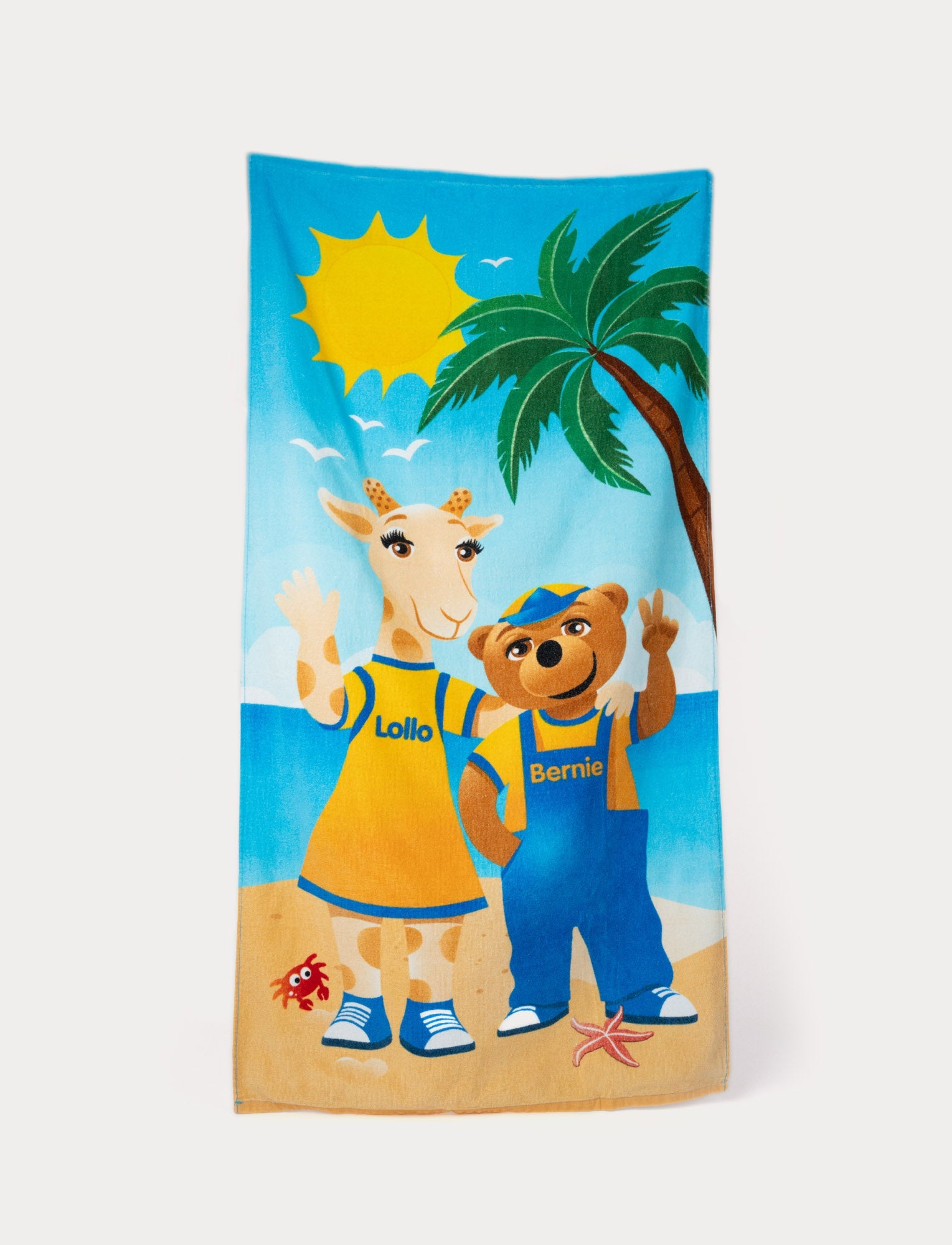  Image of Lollo & Bernie beach towel with a sunny beach scene and colorful character illustrations.