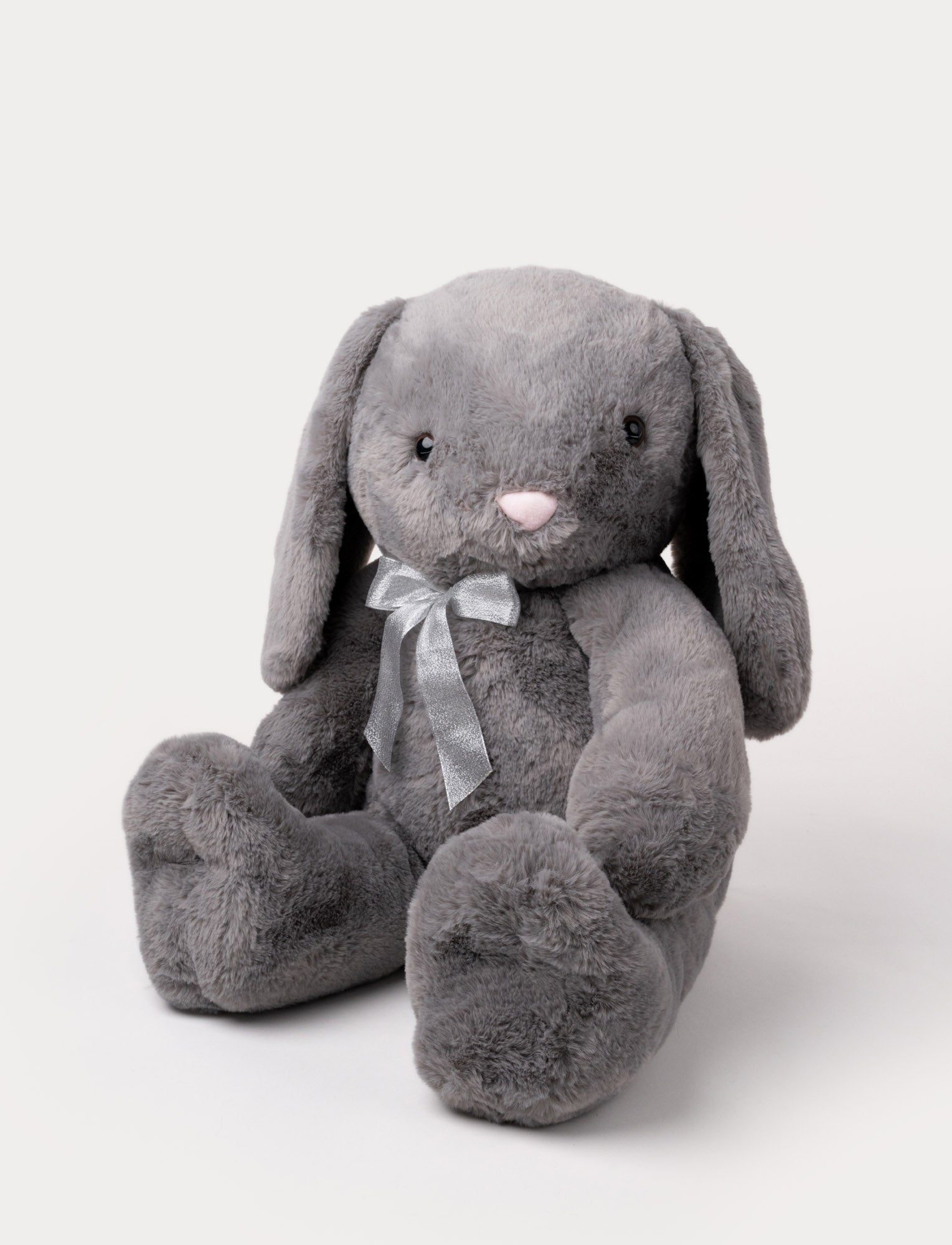  Image of Soft grey plush bunny with long floppy ears, a pink nose, and a silver ribbon around its neck.