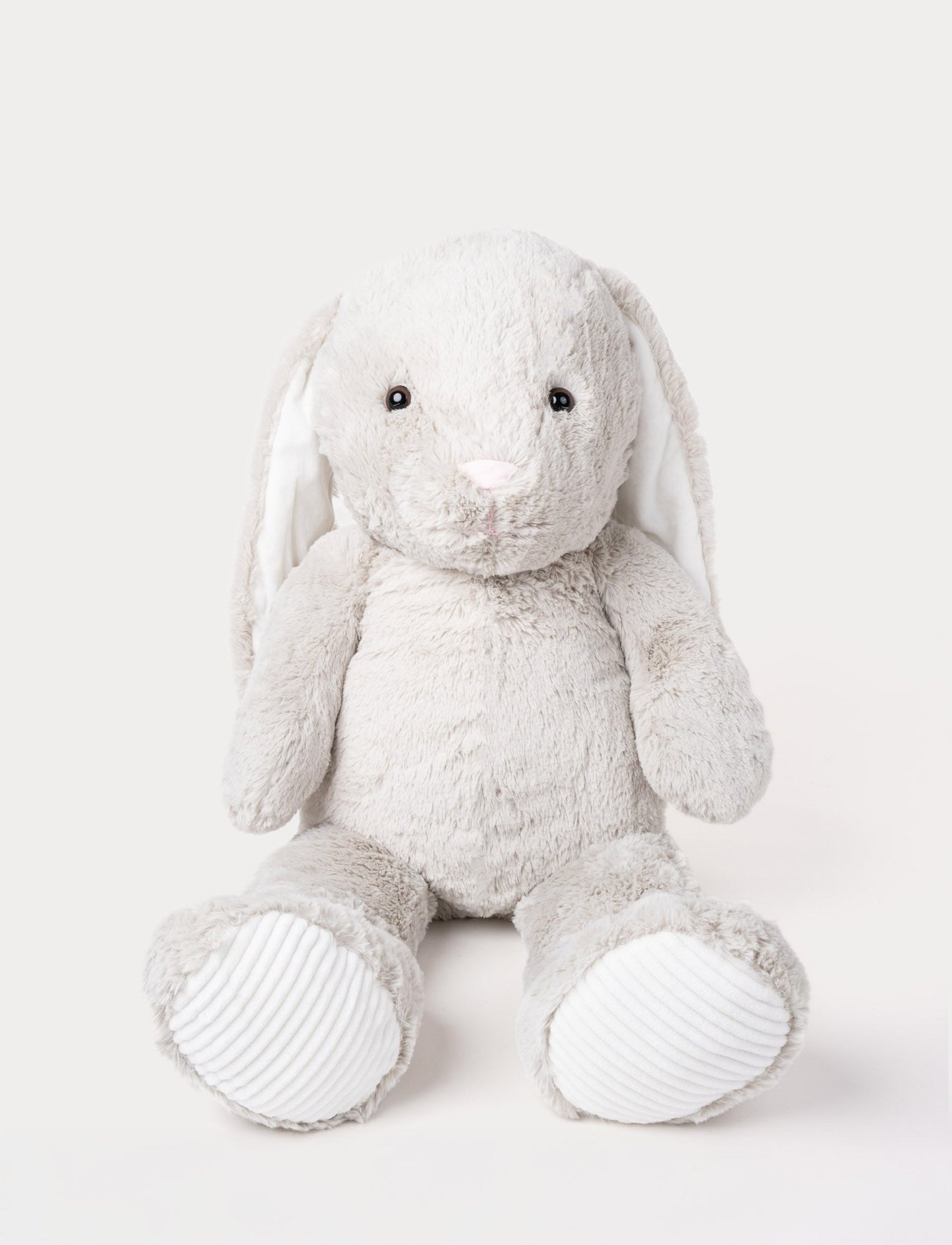 Soft grey plush bunny with long floppy ears, a pink nose, and ribbed white fabric on its paws.