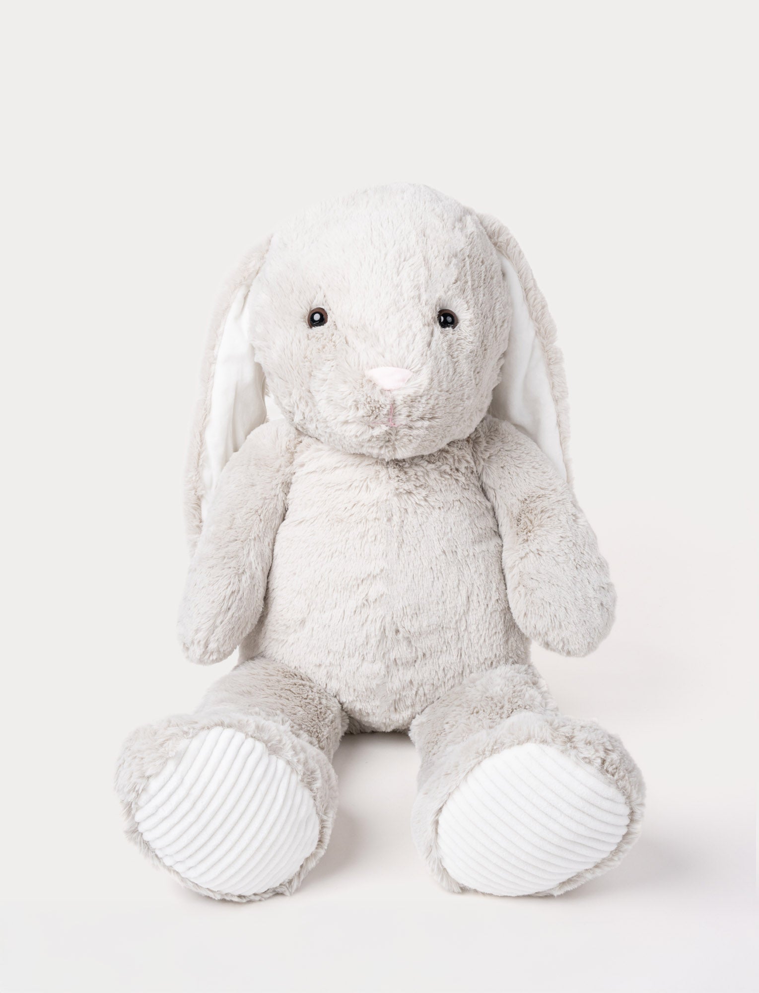  Image of Soft grey plush bunny with long floppy ears, a pink nose, and ribbed white fabric on its paws.