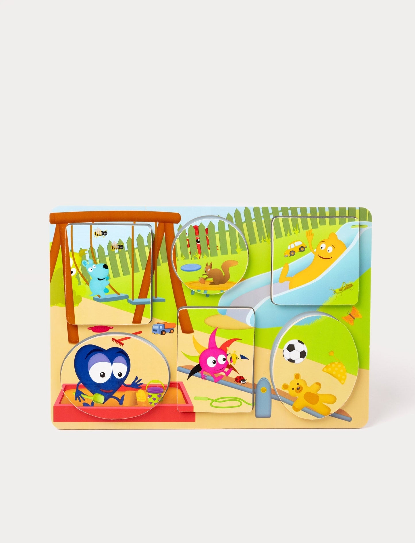 A wooden puzzle featuring Babblarna characters playing in a colorful outdoor playground scene.
