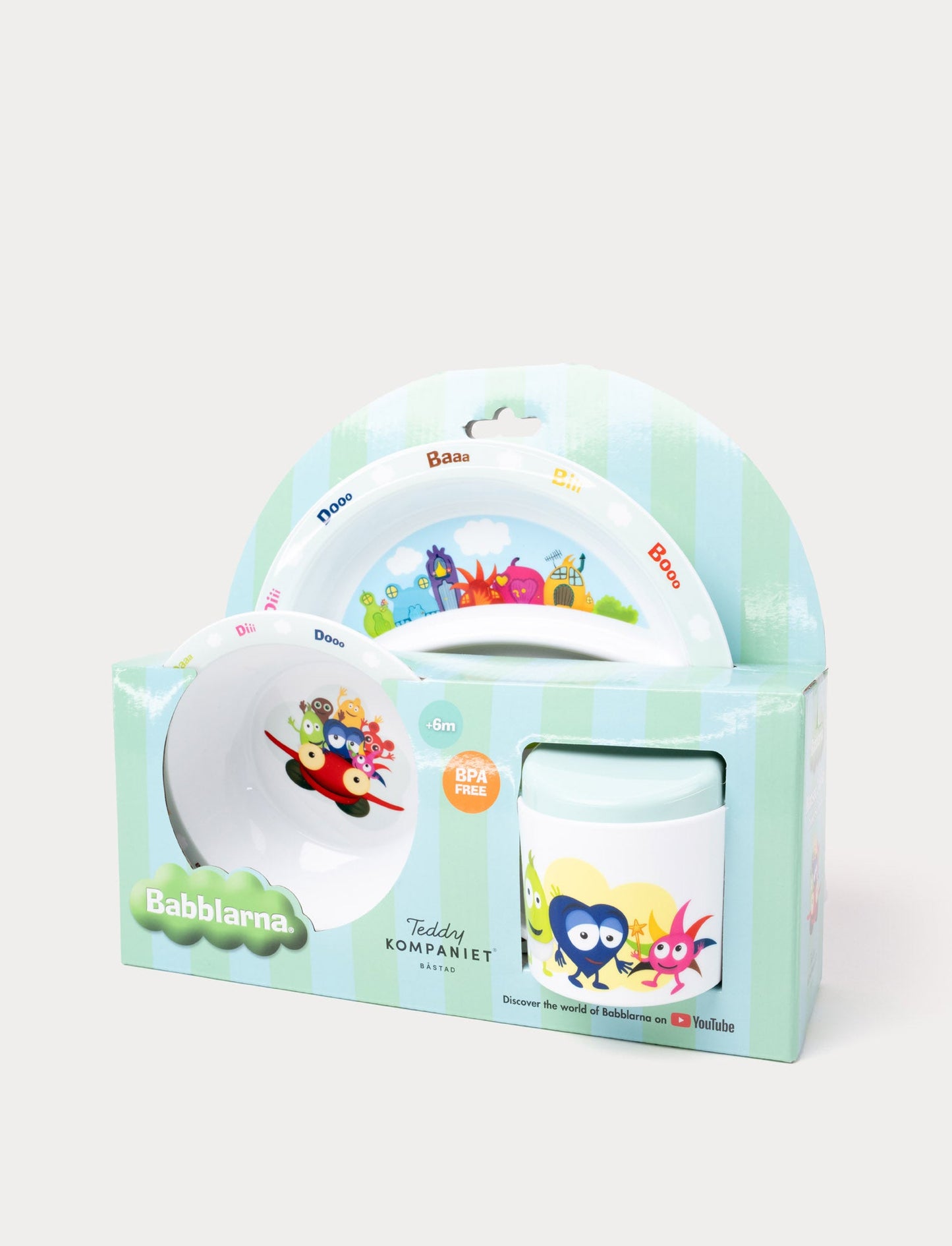 A children's dining set featuring Babblarna characters, including a plate, bowl, and cup in green packaging.
