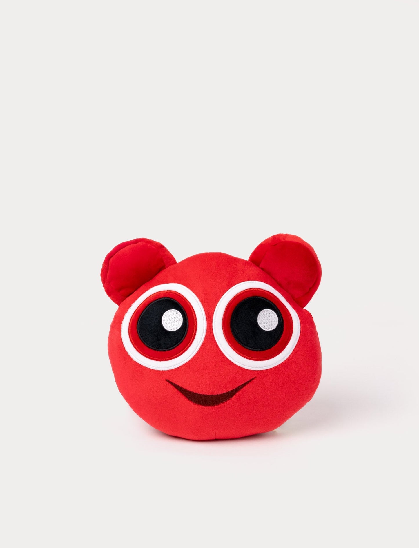 Red plush toy with large round eyes, small ears, and a cheerful embroidered smile.