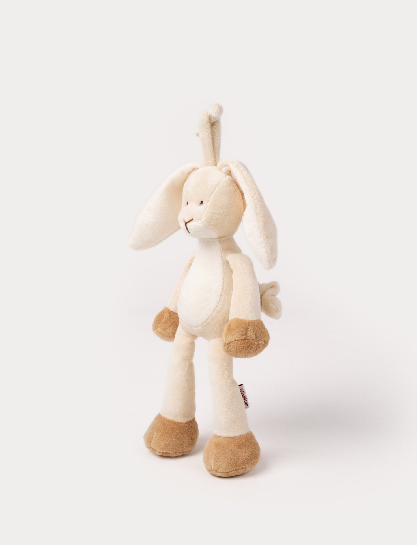 A plush beige bunny music box with floppy ears, a white belly, and a hanging loop.