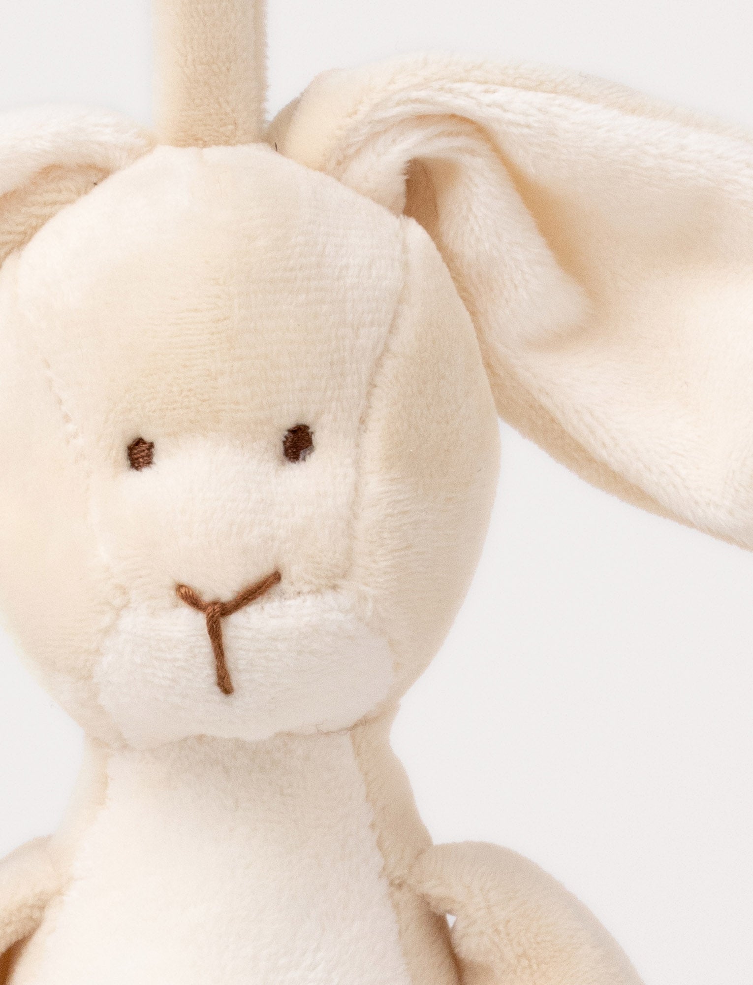  Image of A plush beige bunny music box with floppy ears, a white belly, and a hanging loop.