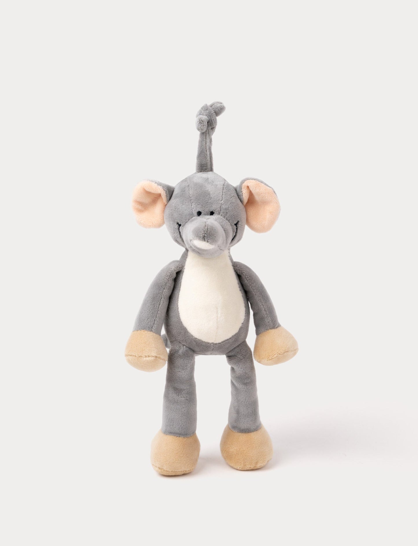 A plush elephant music box with large ears, a white belly, beige feet, and a fabric loop for hanging.