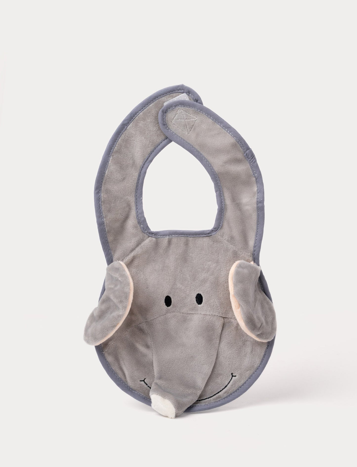 A grey elephant-shaped baby bib with floppy ears, a soft trunk, and a stitched smiling face.