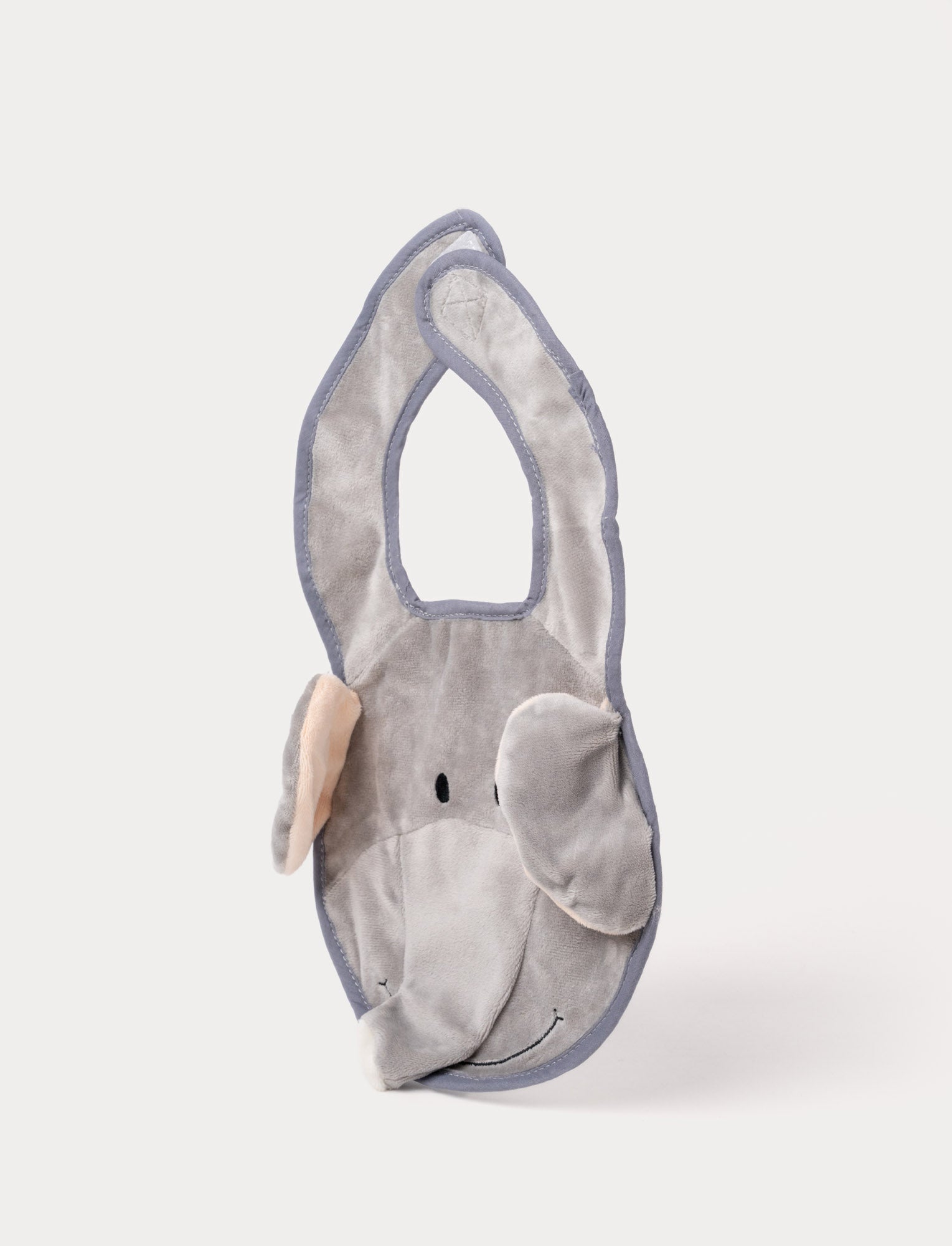  Image of A grey elephant-shaped baby bib with floppy ears, a soft trunk, and a stitched smiling face.