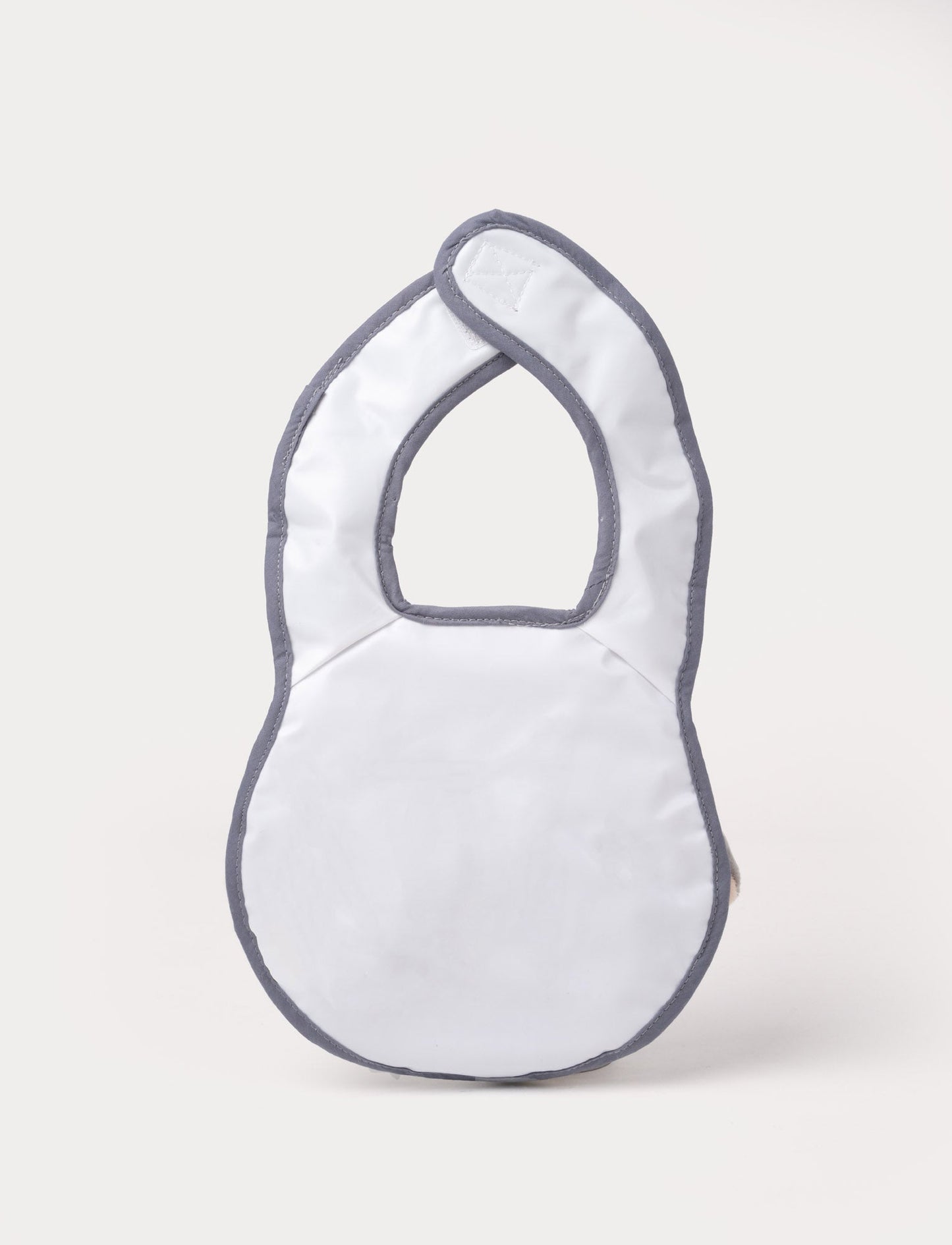 A grey elephant-shaped baby bib with floppy ears, a soft trunk, and a stitched smiling face.