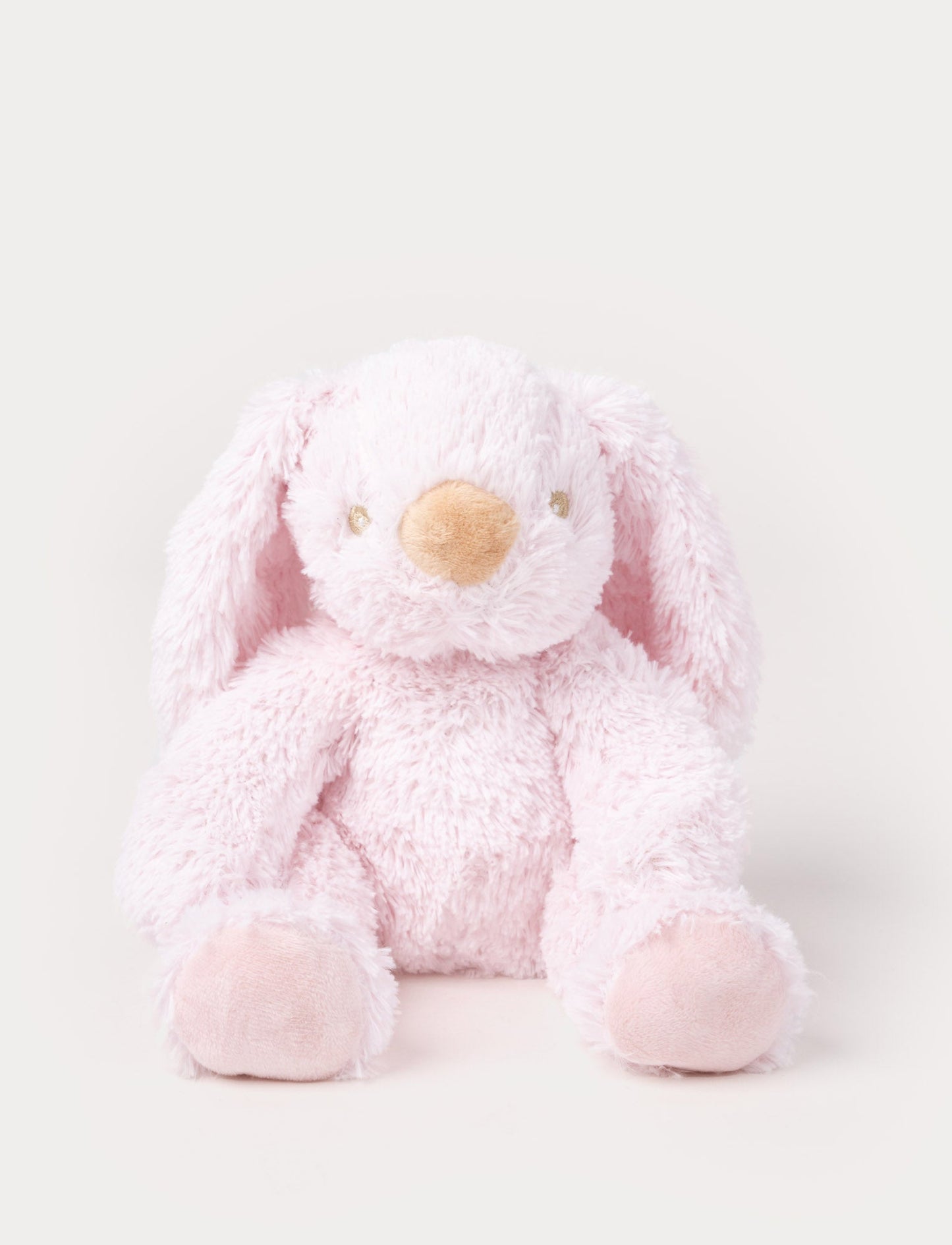 A soft pink plush bunny with floppy ears, a beige nose, and golden-stitched eyes.