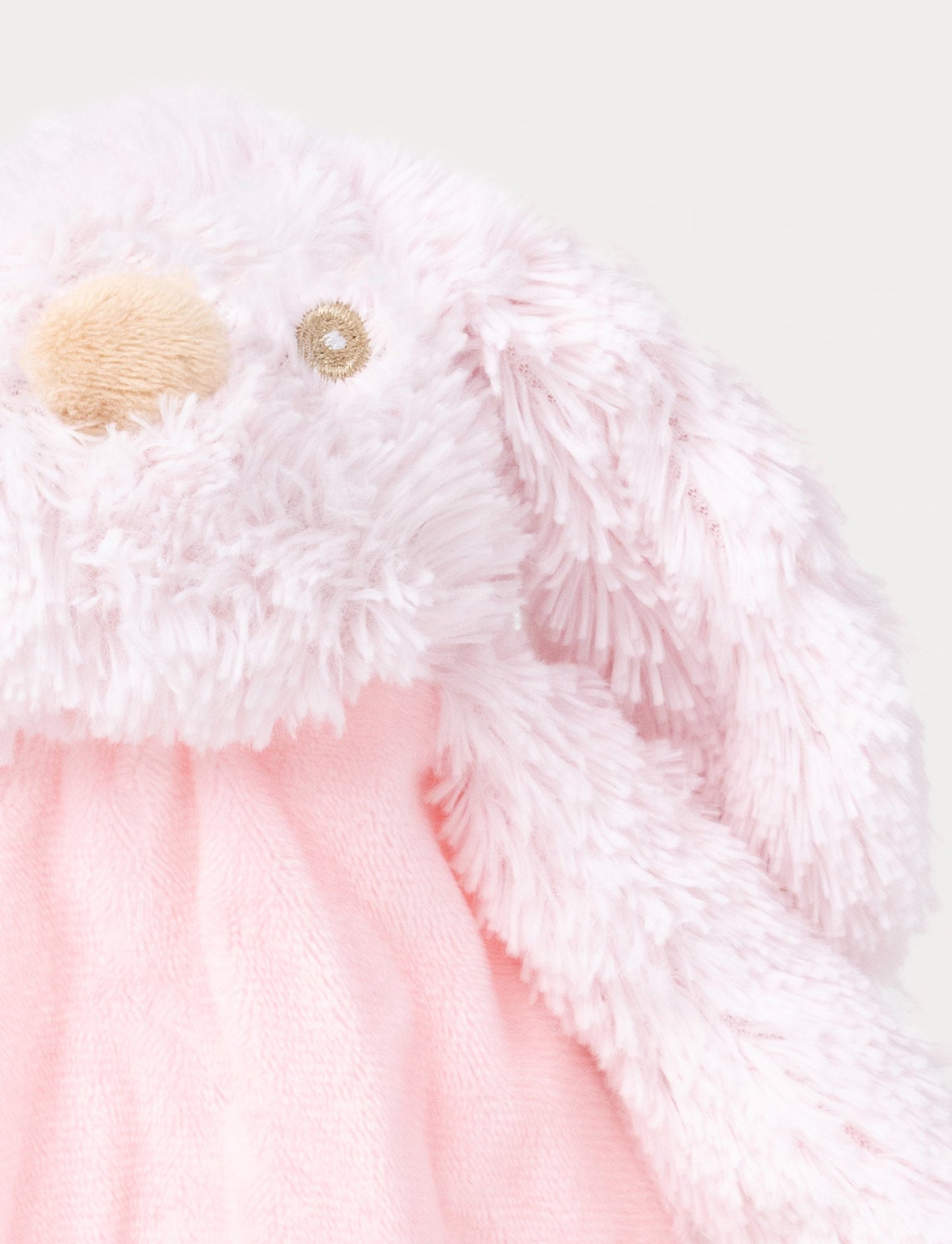 Soft plush bunny with a pink fabric body, floppy furry ears, and fluffy paws.