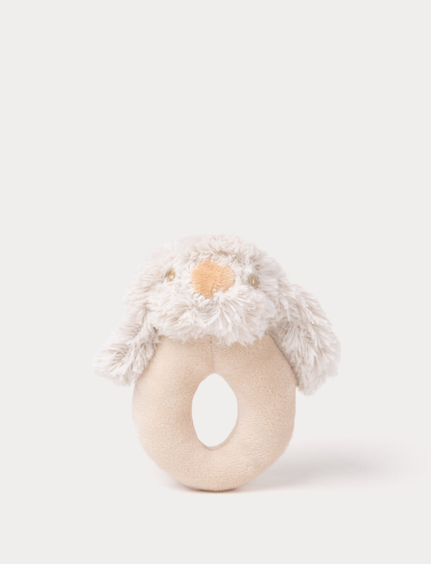 Soft plush puppy rattle with a beige ring handle, fluffy ears, embroidered eyes, and a stitched nose.