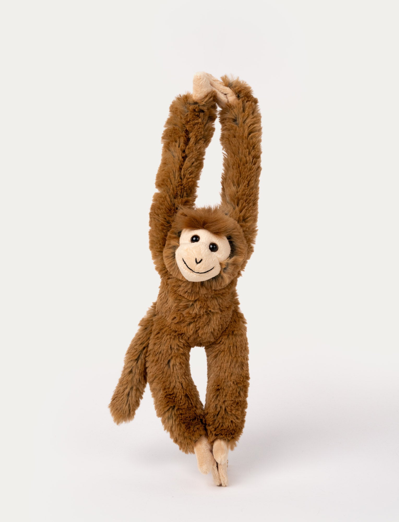  Image of Brown plush monkey with long arms and a smiling face, designed to hang by its hands with Velcro.