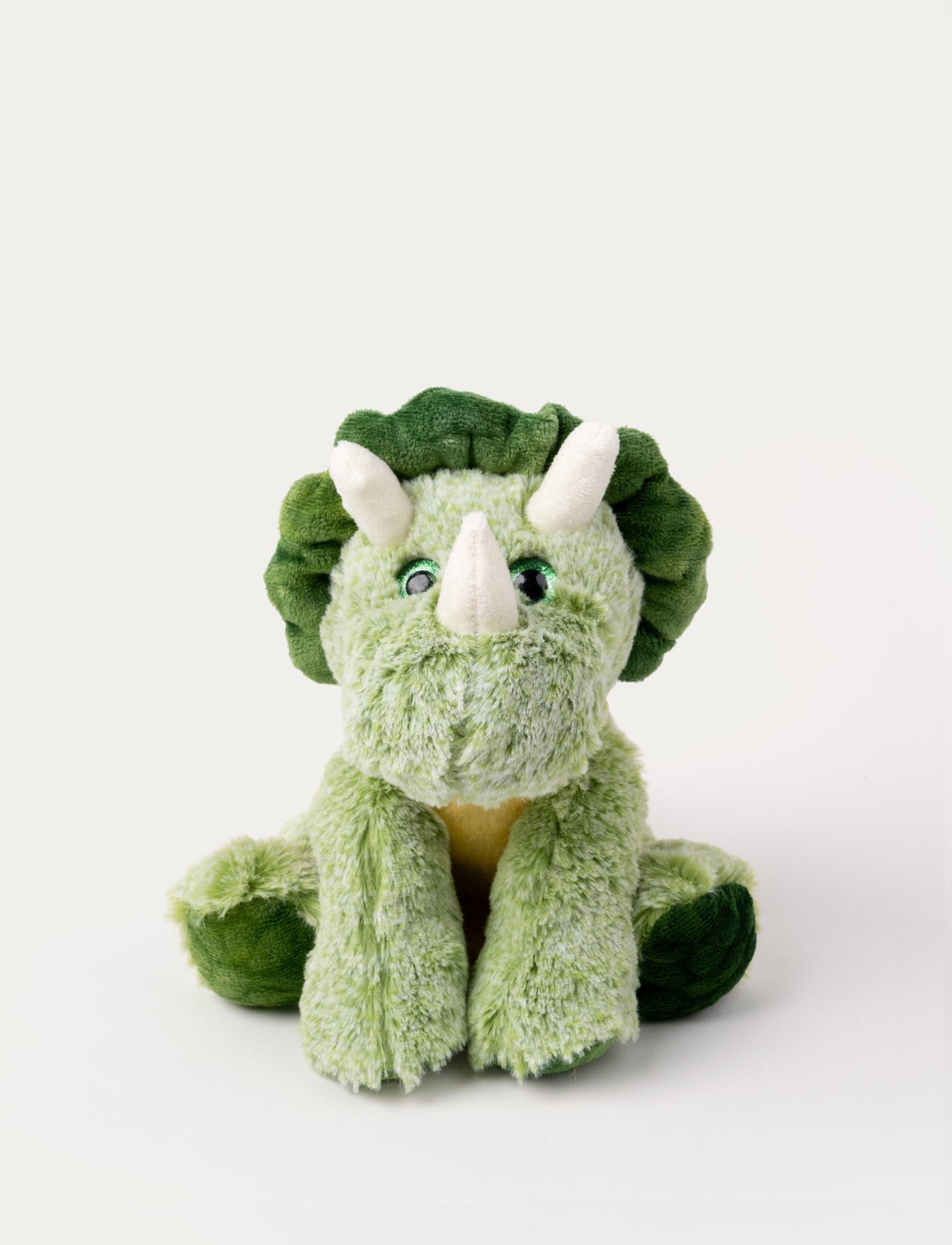 Soft green triceratops plush with three white horns, a dark green frill, and embroidered eyes.