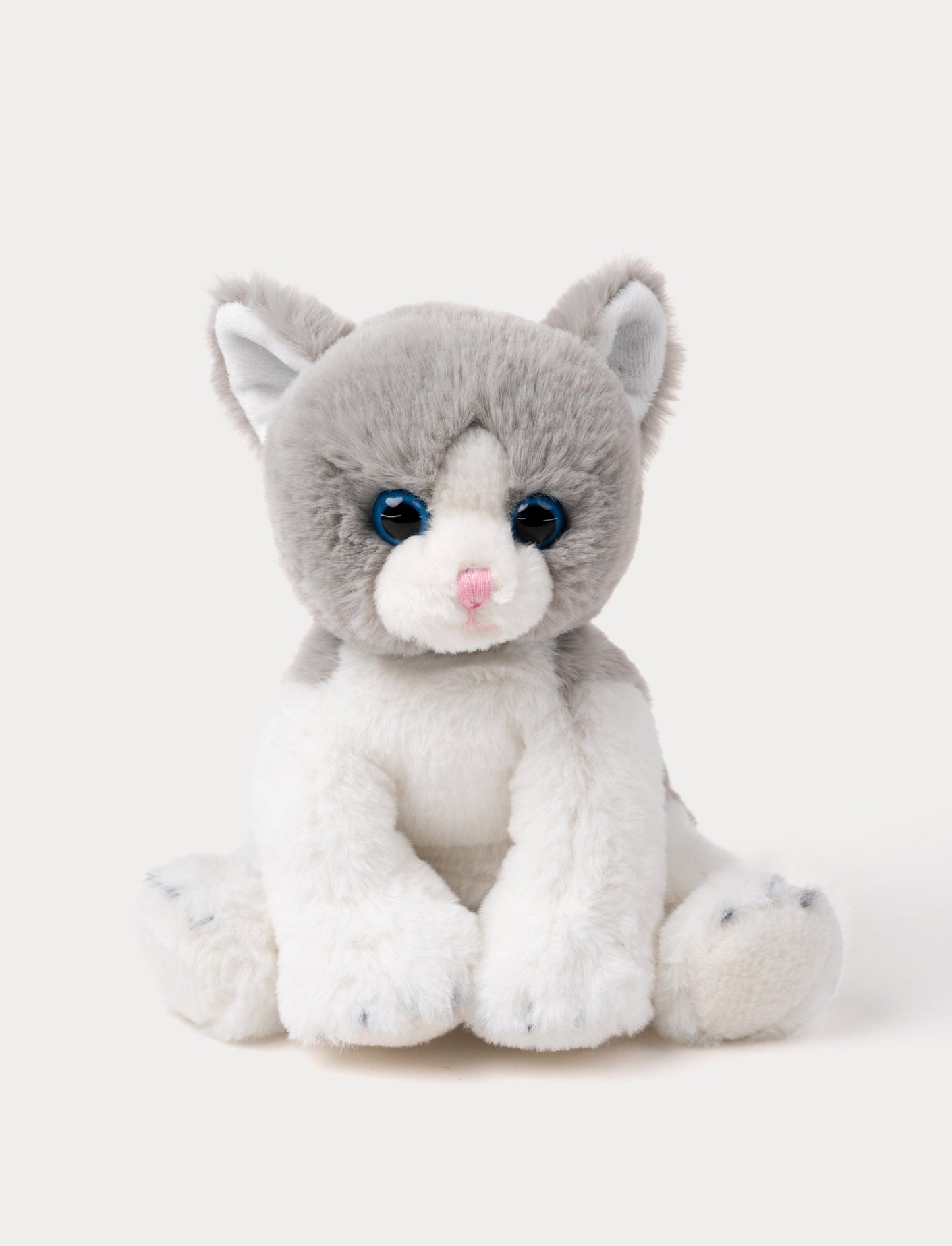 Soft grey and white kitten plush with blue eyes, a pink nose, and white paws.