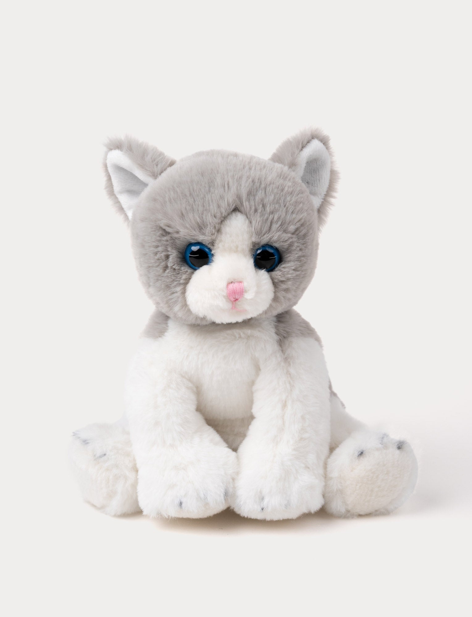  Image of Soft grey and white kitten plush with blue eyes, a pink nose, and white paws.