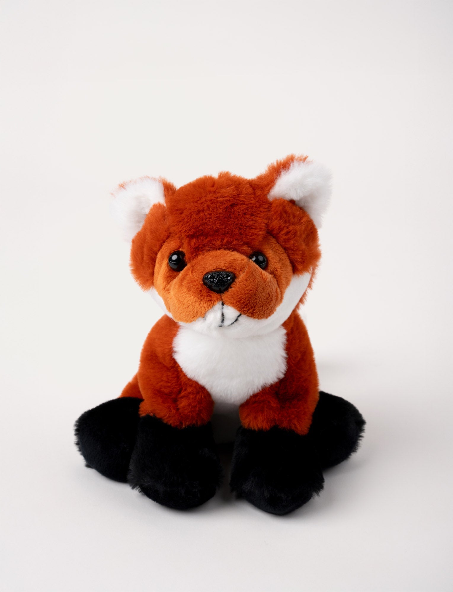  Image of Soft red fox plush with white accents, black paws, and shiny black eyes.