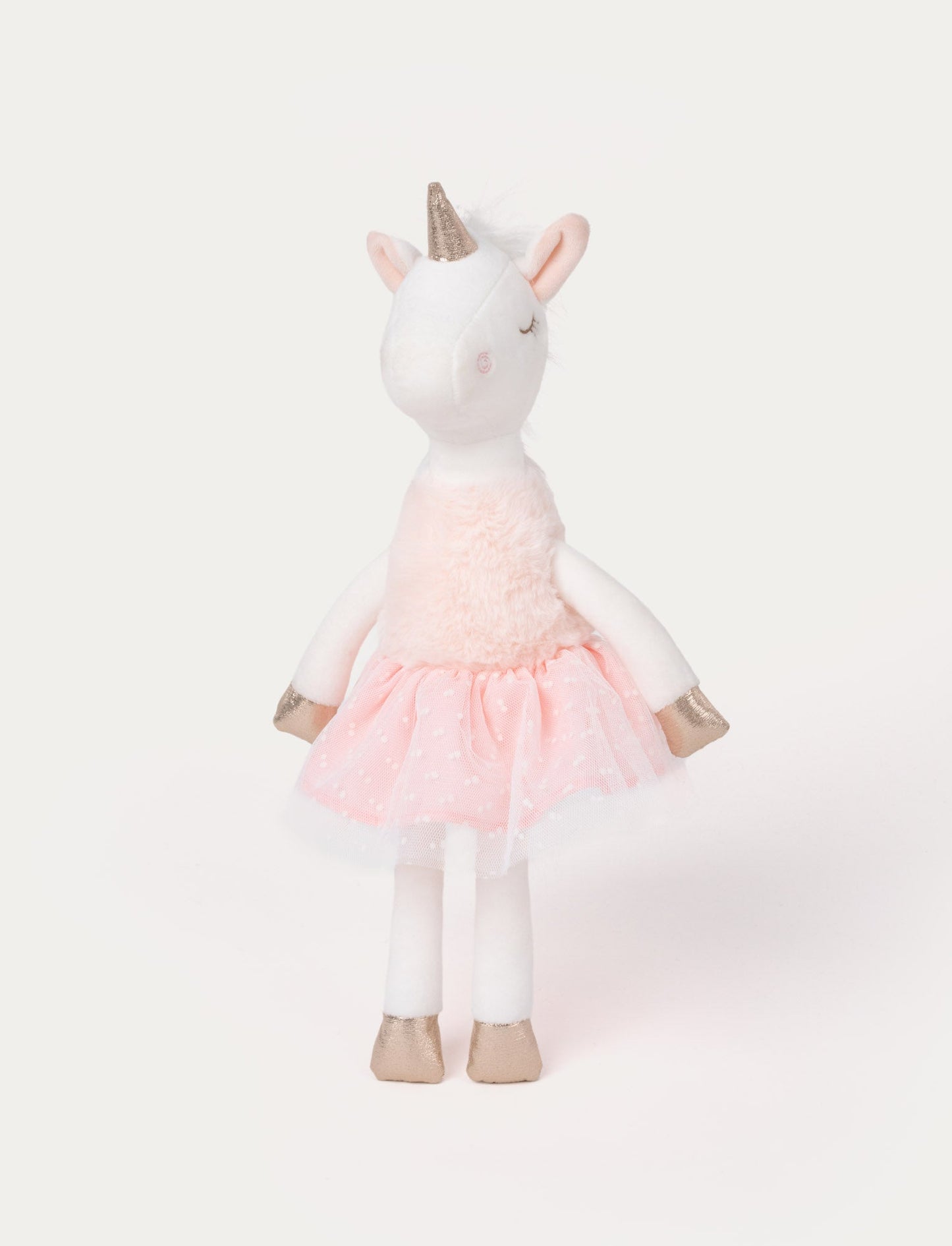 Soft white plush unicorn with a gold horn, pink skirt, and gold hooves. Featuring closed embroidered eyes.