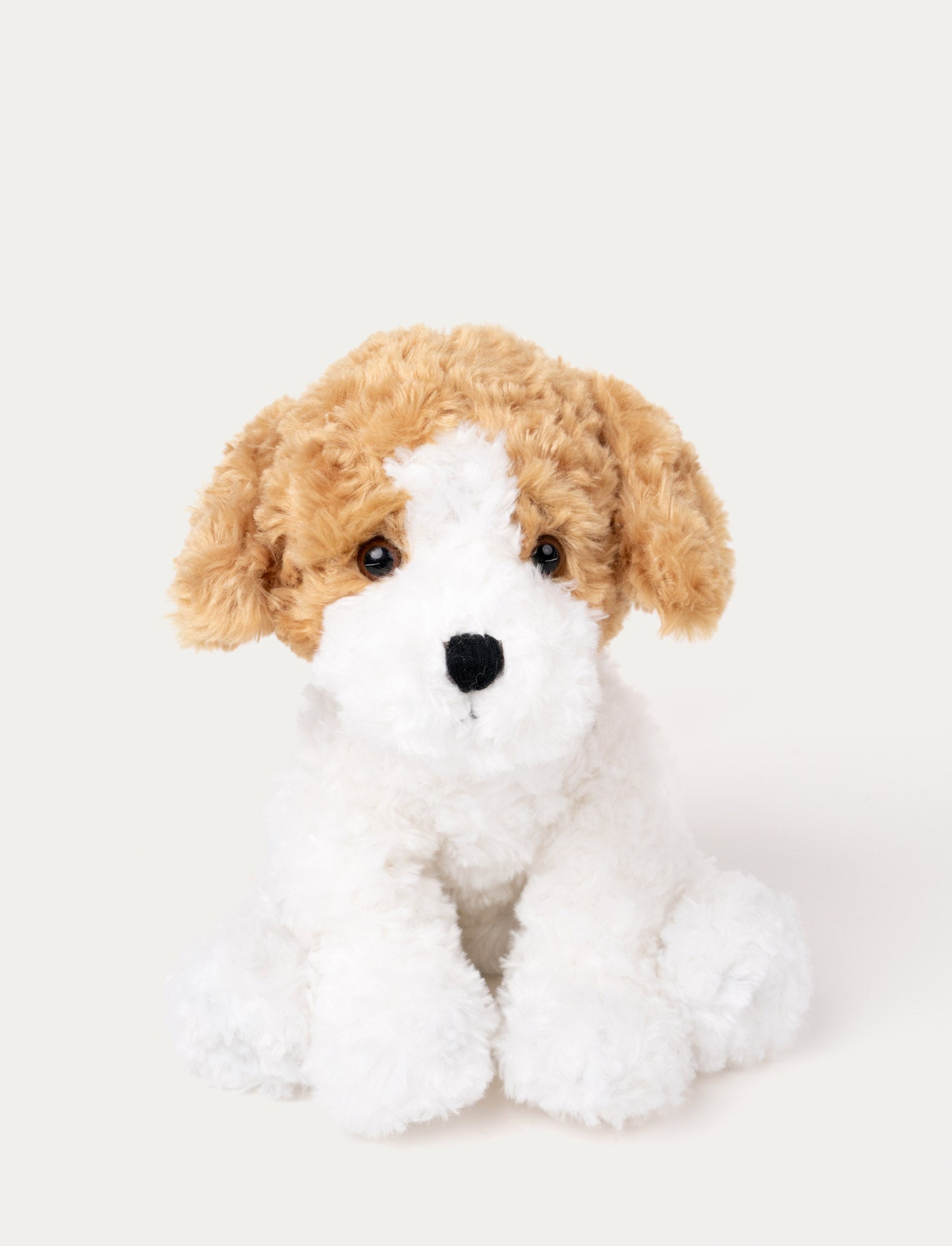  Image of Soft plush dog with curly white fur, light brown floppy ears, black eyes, and a stitched black nose.