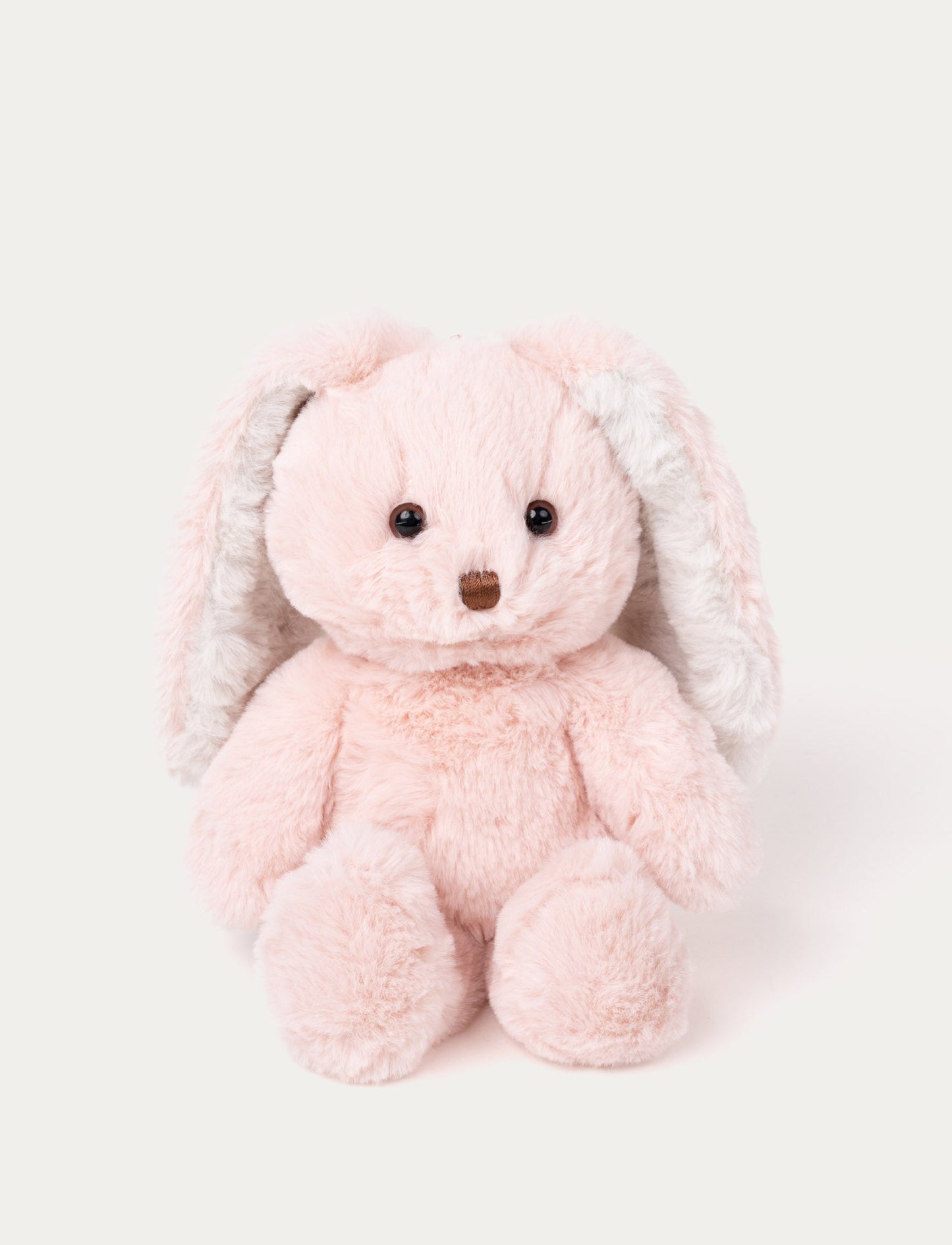 Soft pink plush bunny with long floppy ears, brown eyes, and a stitched brown nose.