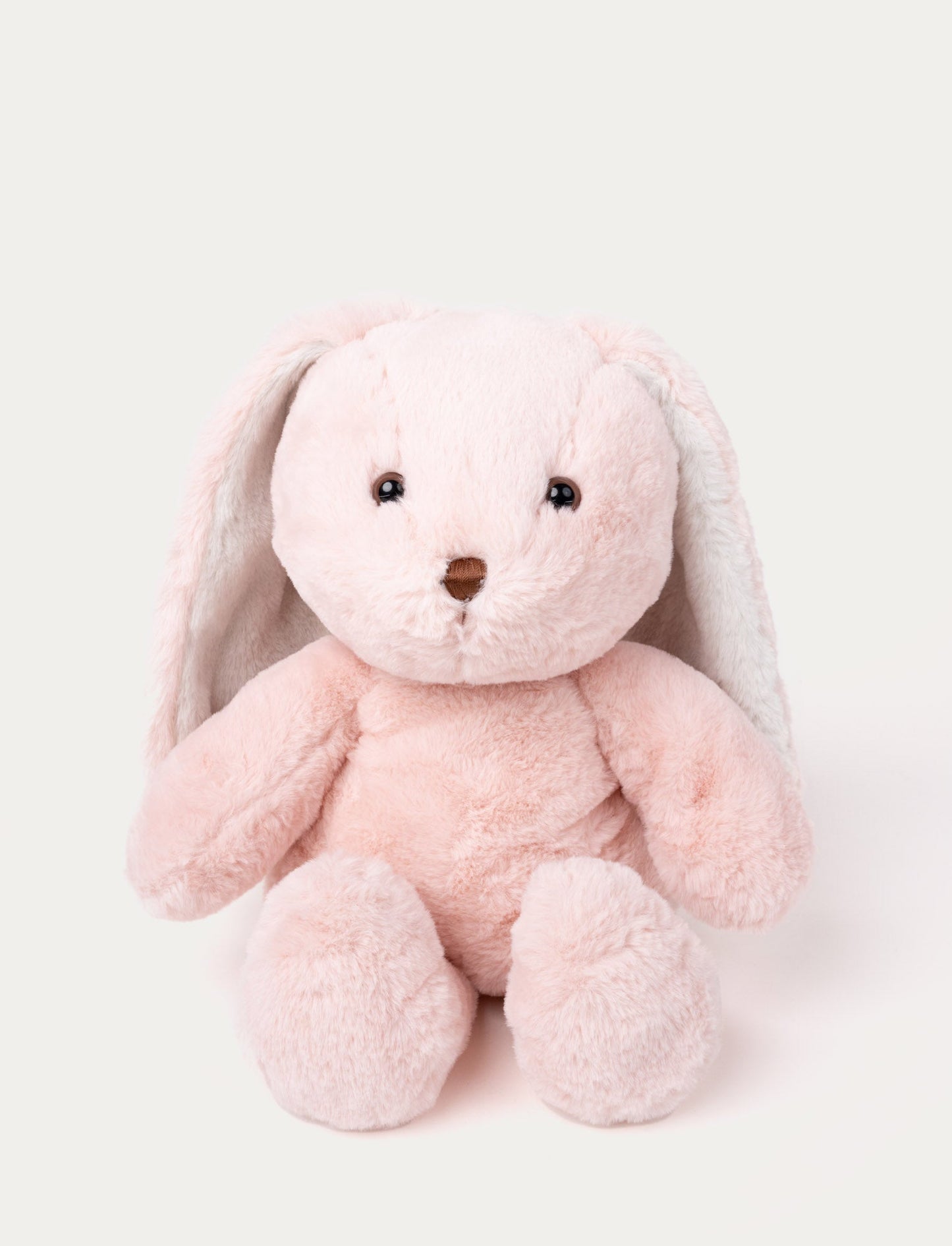 Soft pink plush bunny with long floppy ears, brown eyes, and a stitched brown nose.