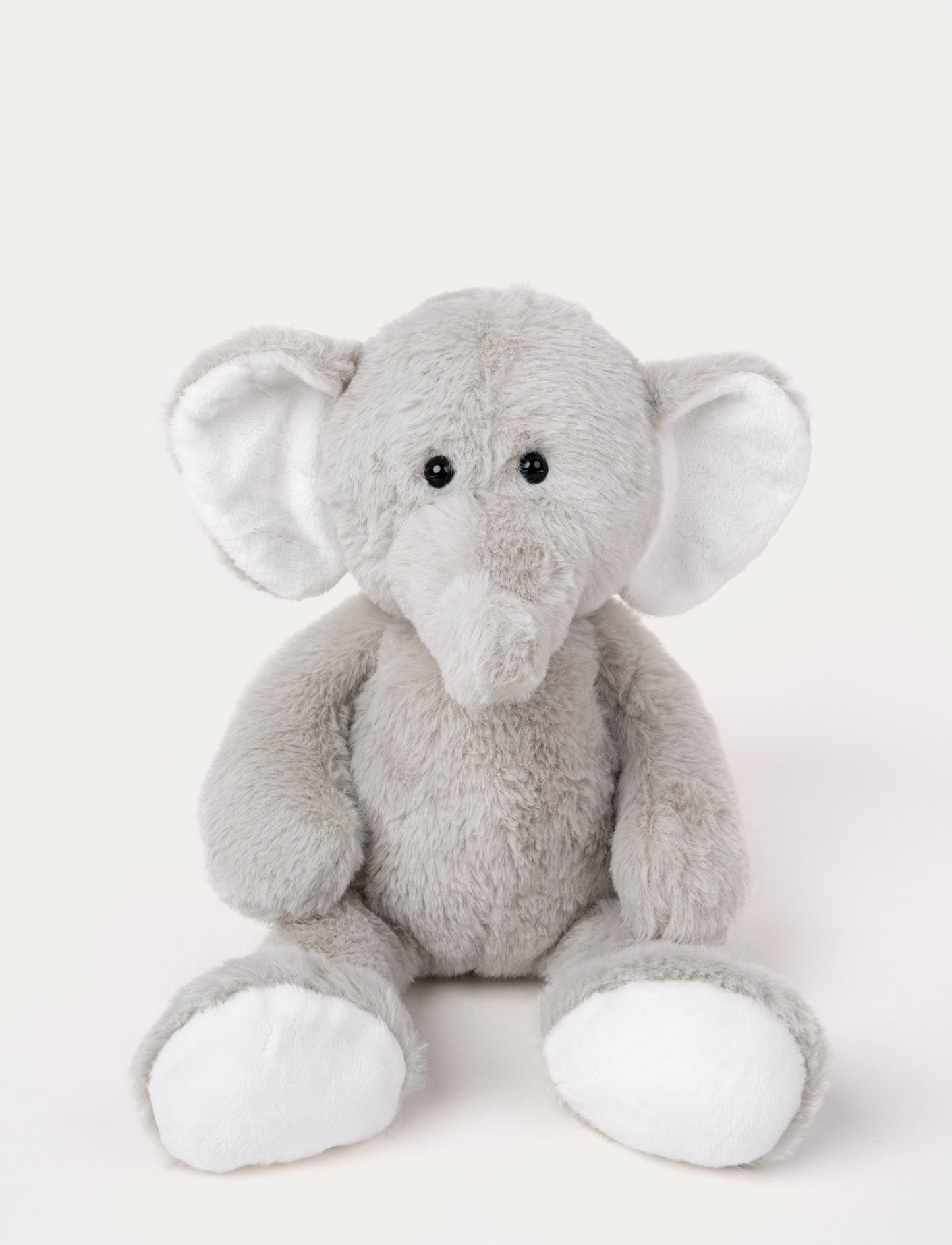 Soft, grey plush elephant with large floppy ears, black button eyes, and white accents on ears and feet.