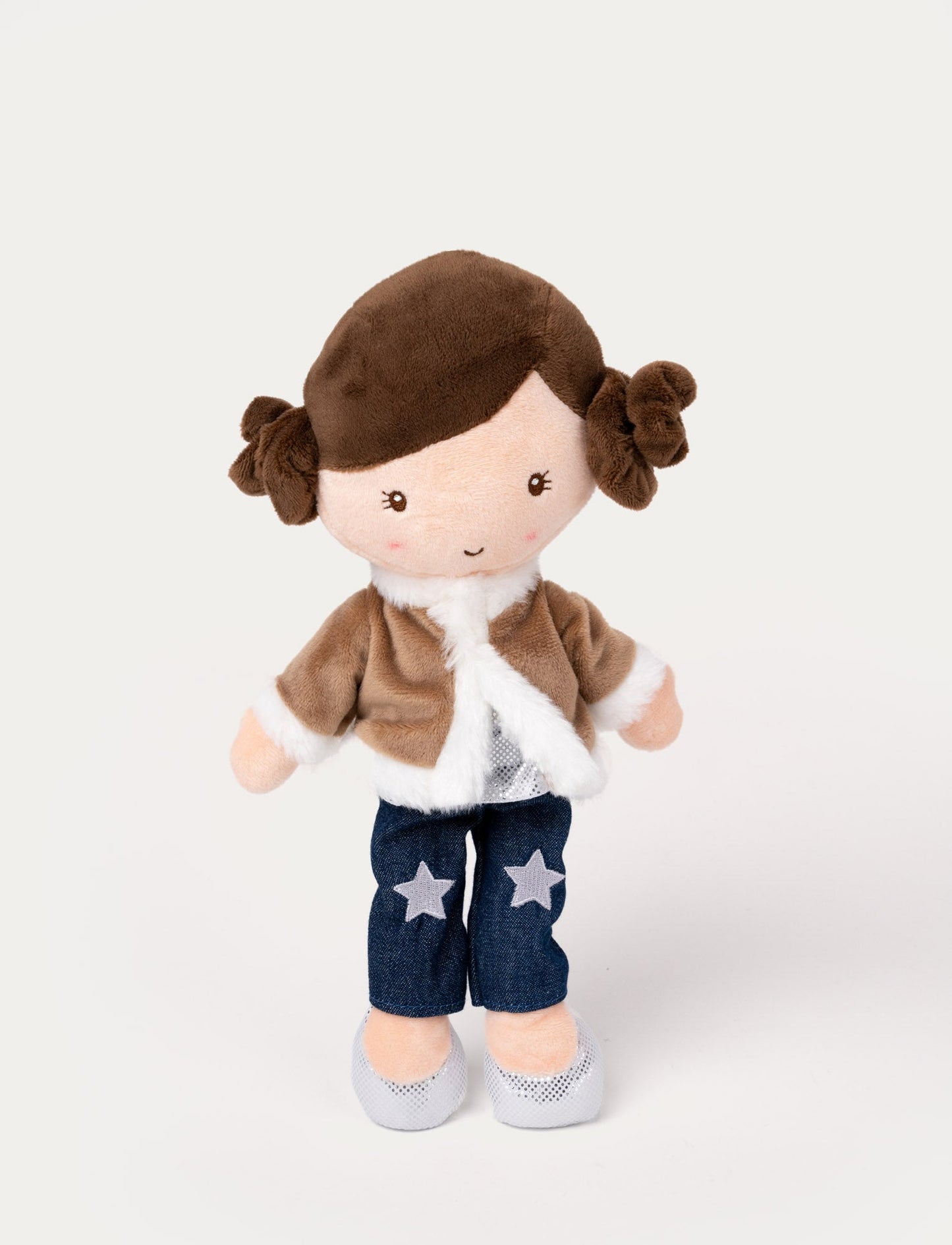 Plush doll with brown hair in buns, wearing a faux fur jacket, denim pants with star patches, and silver shoes.