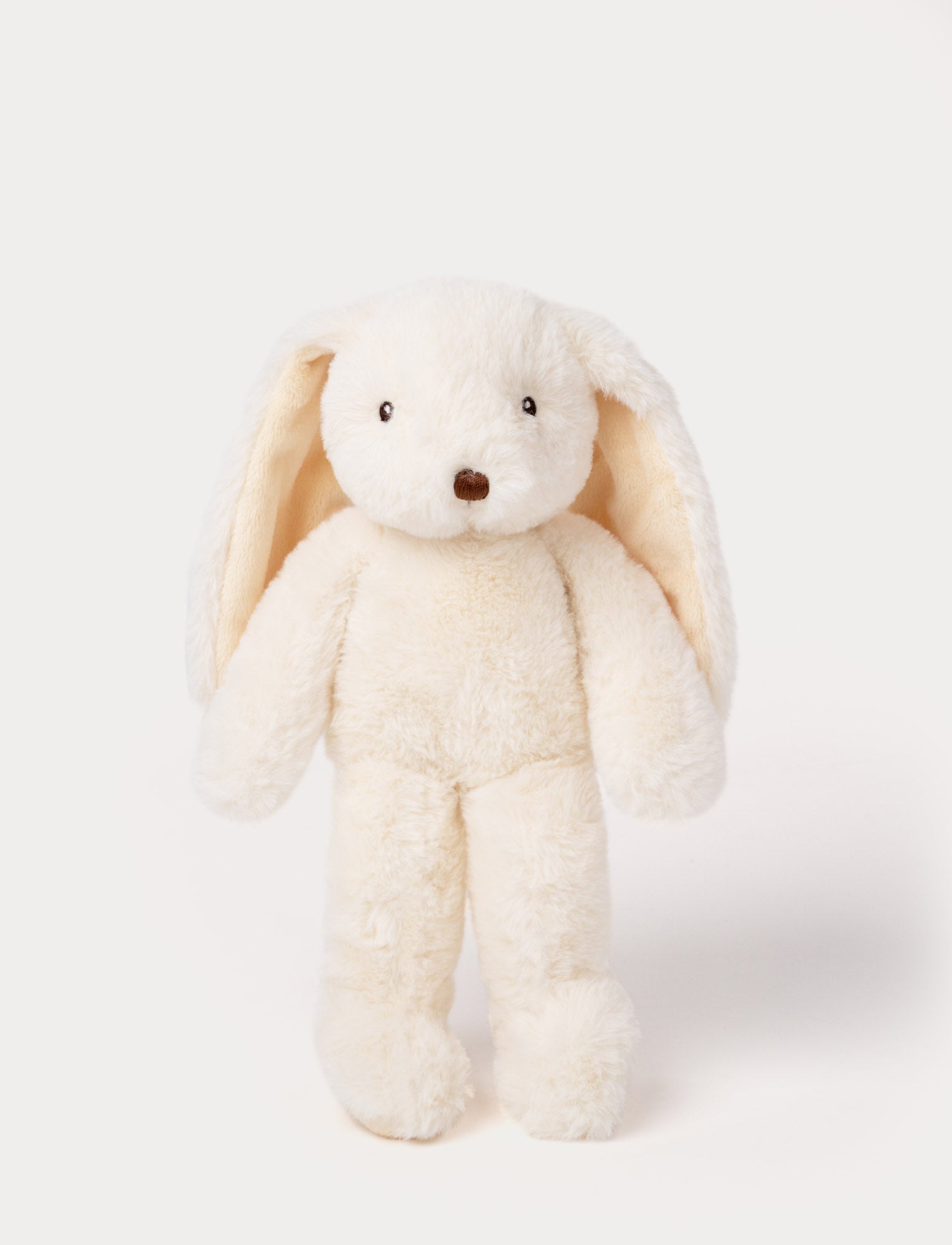  Image of Soft, plush bunny with cream-colored fur, long floppy ears, black button eyes, and a small stitched nose.