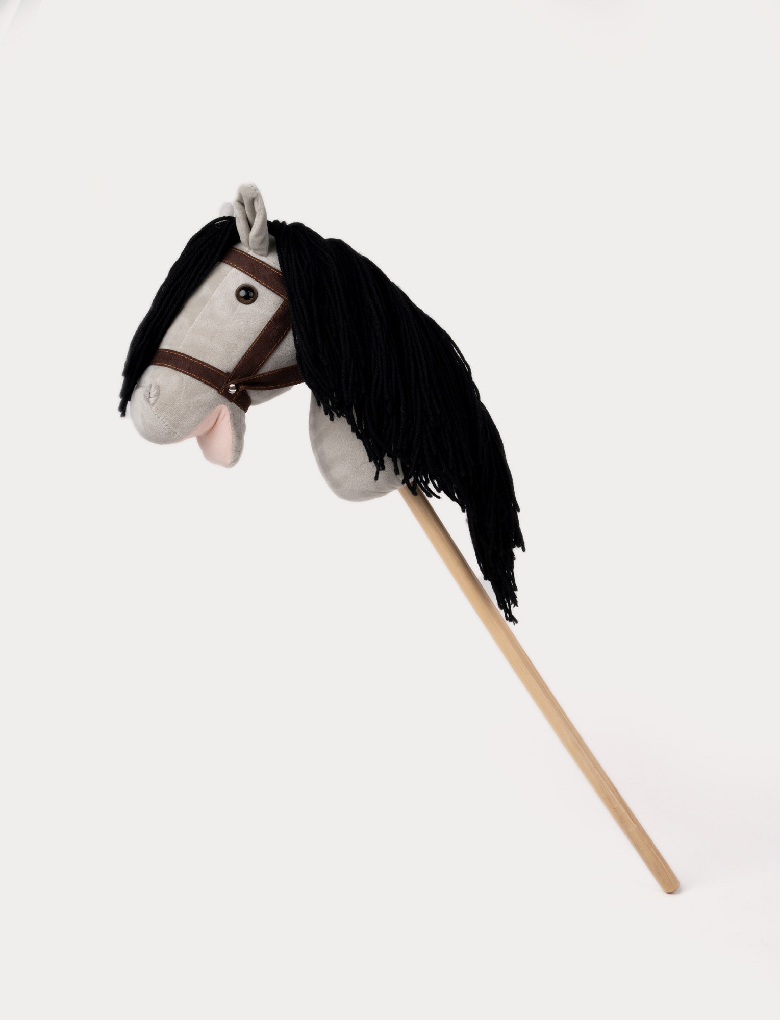  Image of Light gray hobby horse with a soft mane, brown bridle, and a sturdy wooden stick.