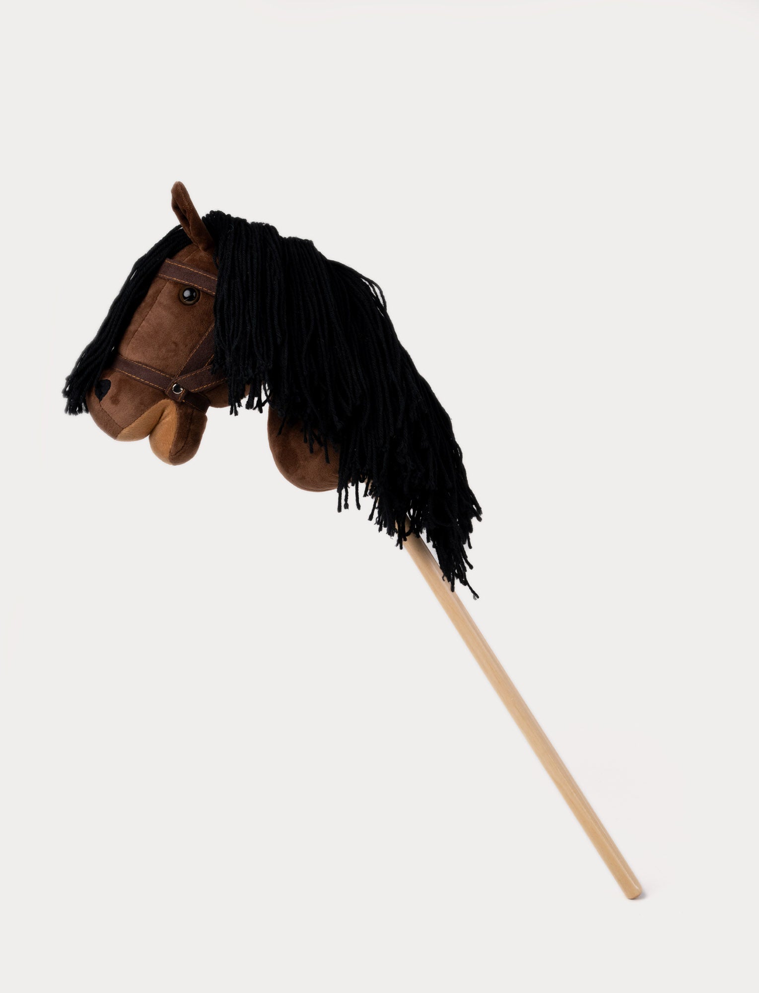  Image of Brown hobby horse with a soft mane, stylish bridle, and a sturdy wooden stick.