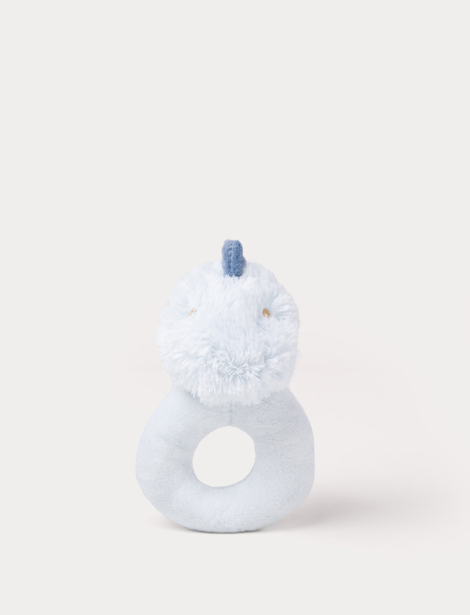  Image of Light blue plush rattle shaped like a dinosaur with a soft ring handle and a small fabric crest on its head.