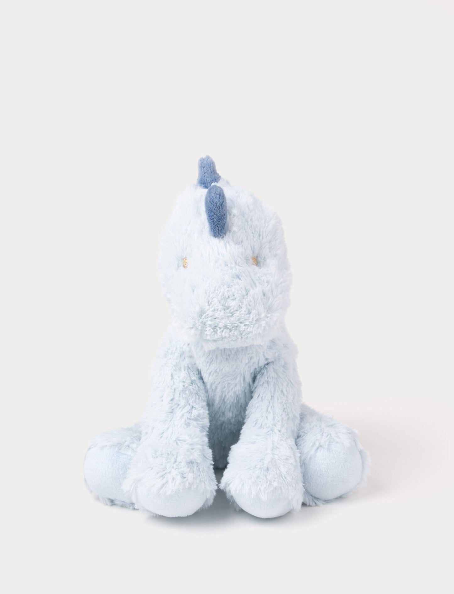 Soft plush light blue dino with dark blue fabric spikes and a fluffy texture.
