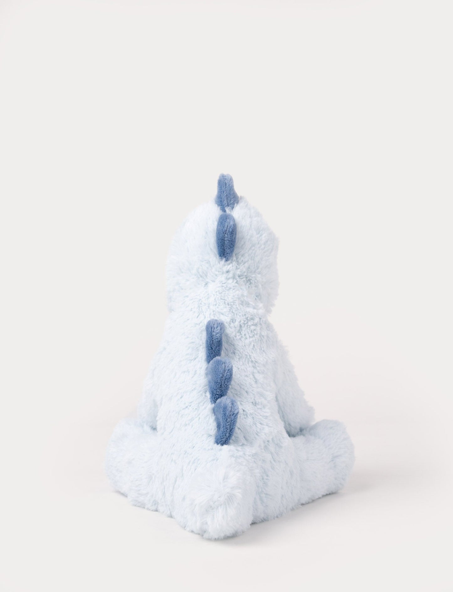 Soft plush light blue dino with dark blue fabric spikes and a fluffy texture.