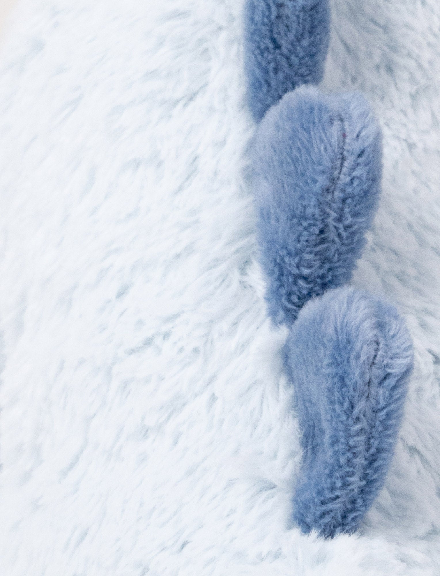 Image of Soft plush light blue dino with dark blue fabric spikes and a fluffy texture.