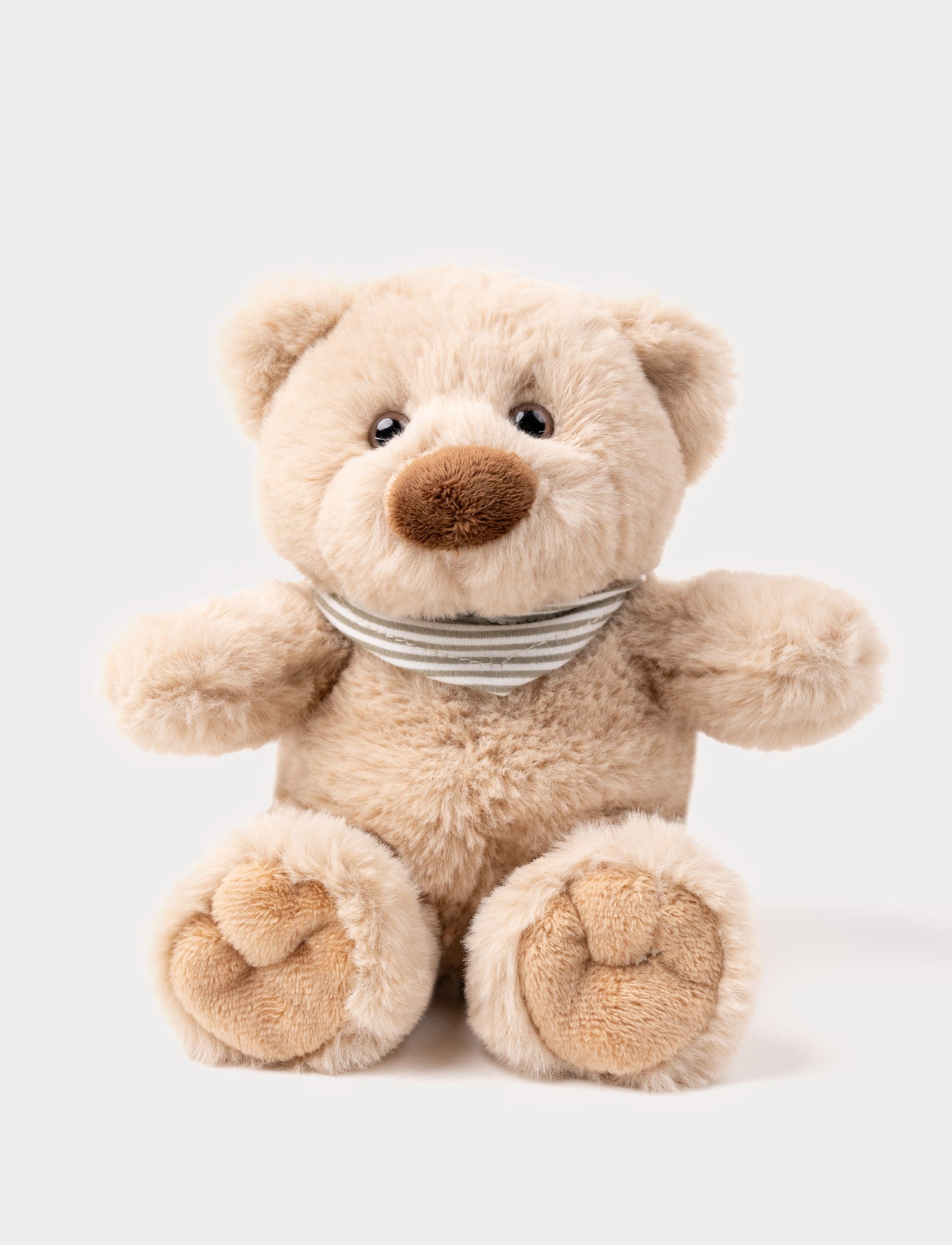  Image of A light beige teddy bear with an adorable scarf made of organic cotton.