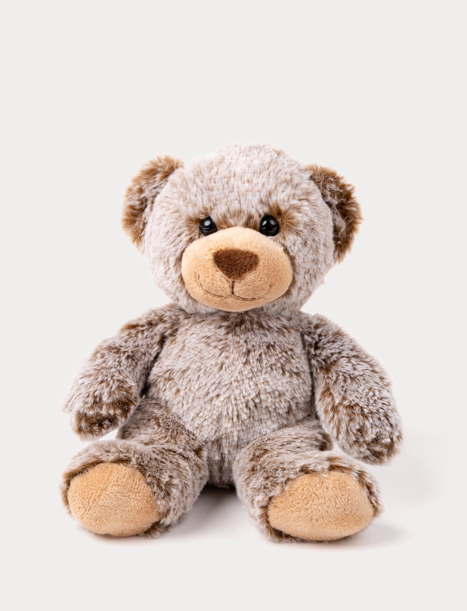  Image of A teddy bear with mottled brown fur, velvety paws, bright eyes, and a cheerful expression.
