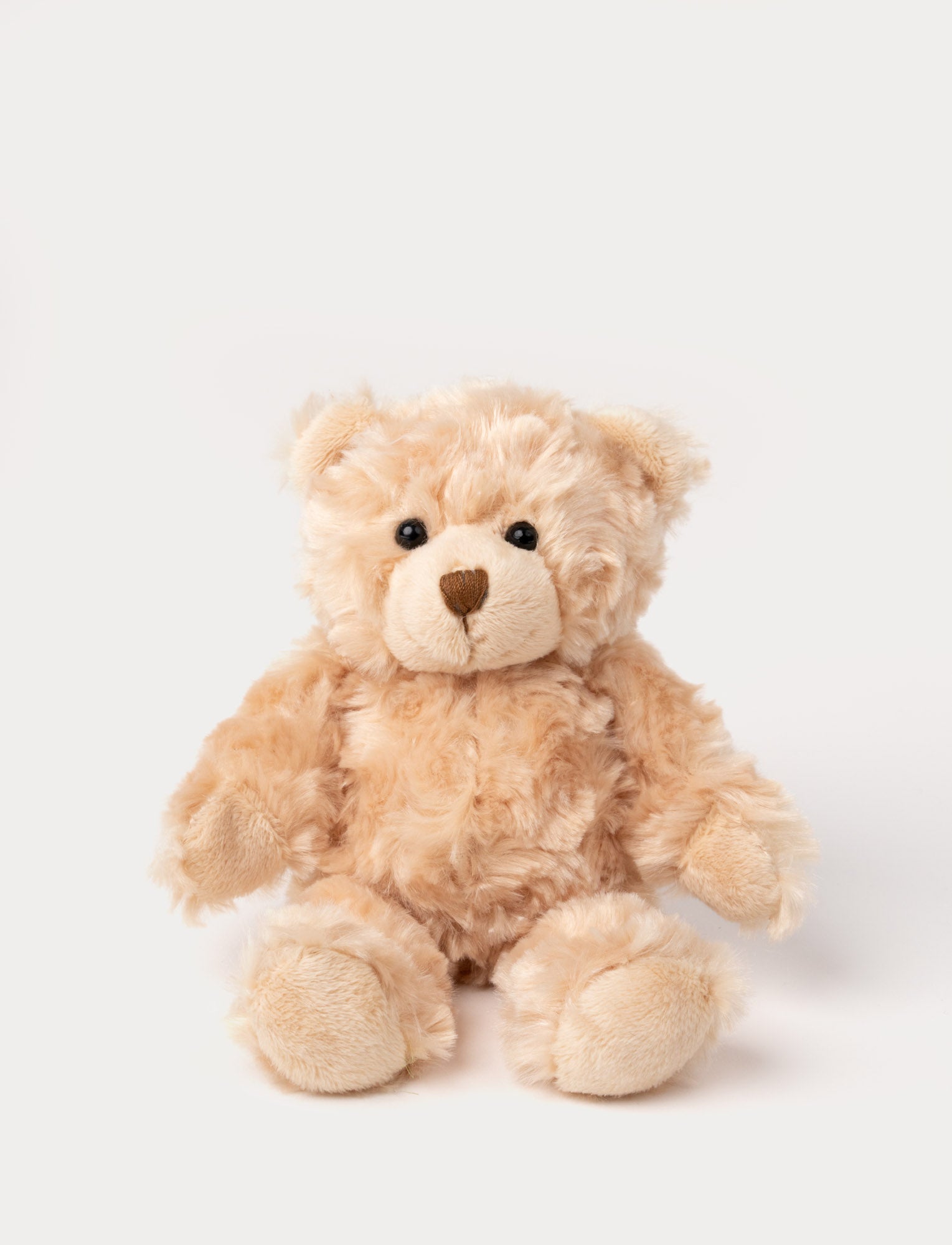  Image of A teddy bear with fluffy beige fur, light brown details, and a cheerful expression.