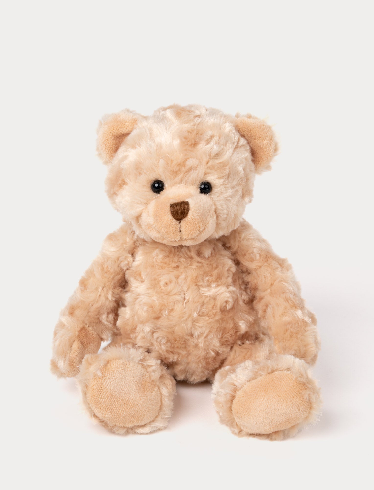  Image of Soft, plush teddy bear with curly light brown fur, black button eyes, a stitched brown nose, and beige paw pads.