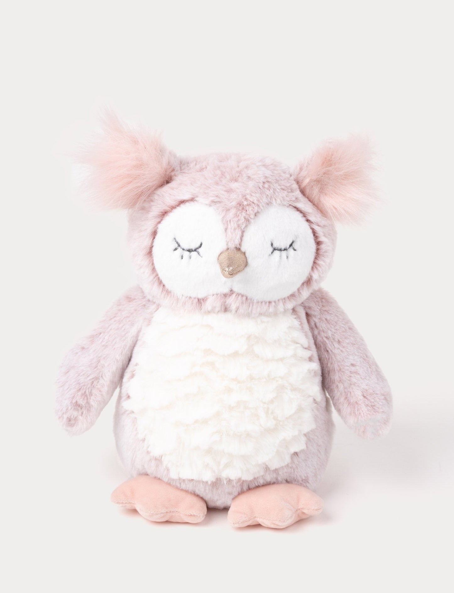 An owl with cozy pink-mottled fur, a white belly, long tufts, and a shimmering silver beak.